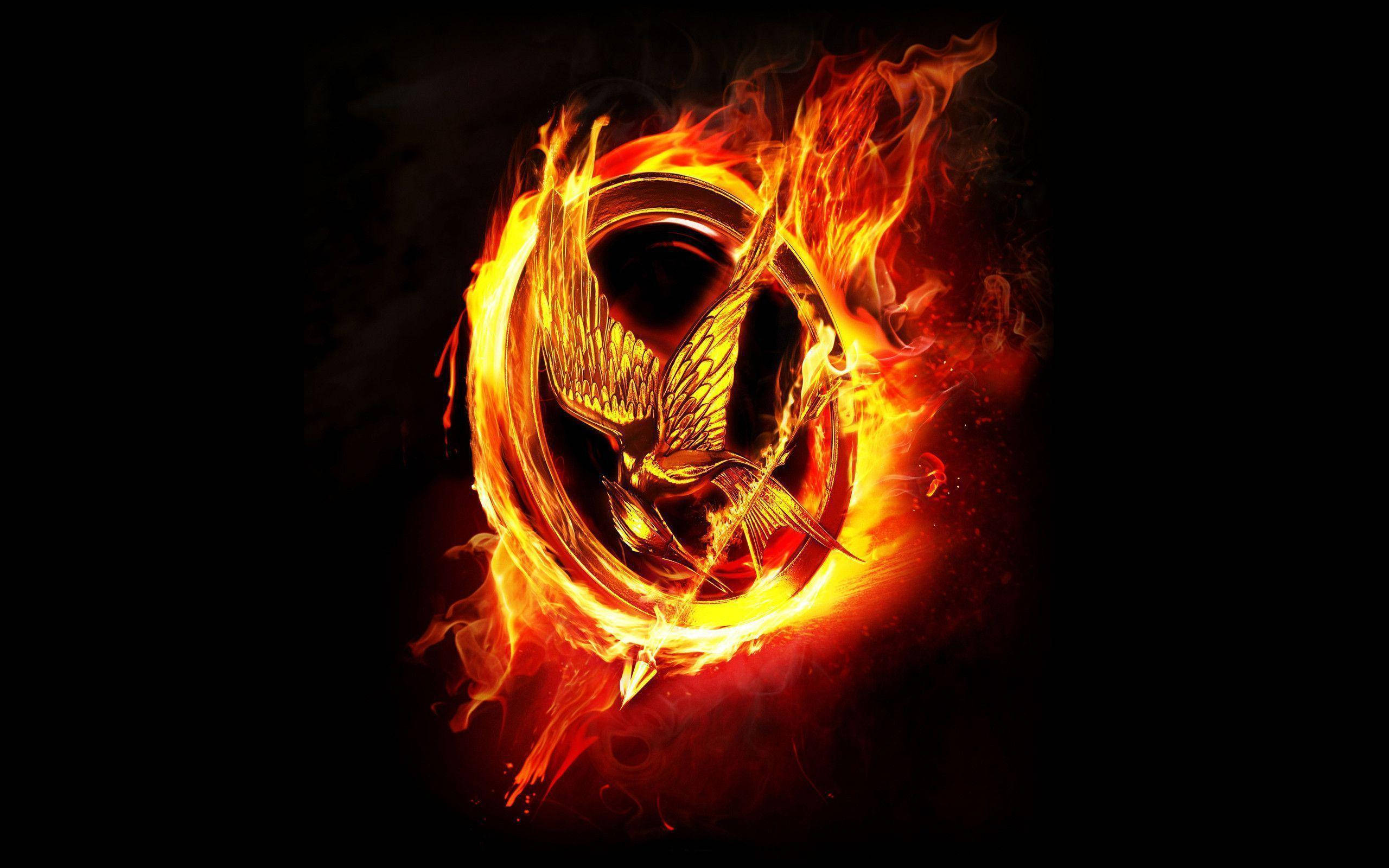 The Hunger Games, flaming logo, golden mockingjay bird, 2K Desktop Wallpaper