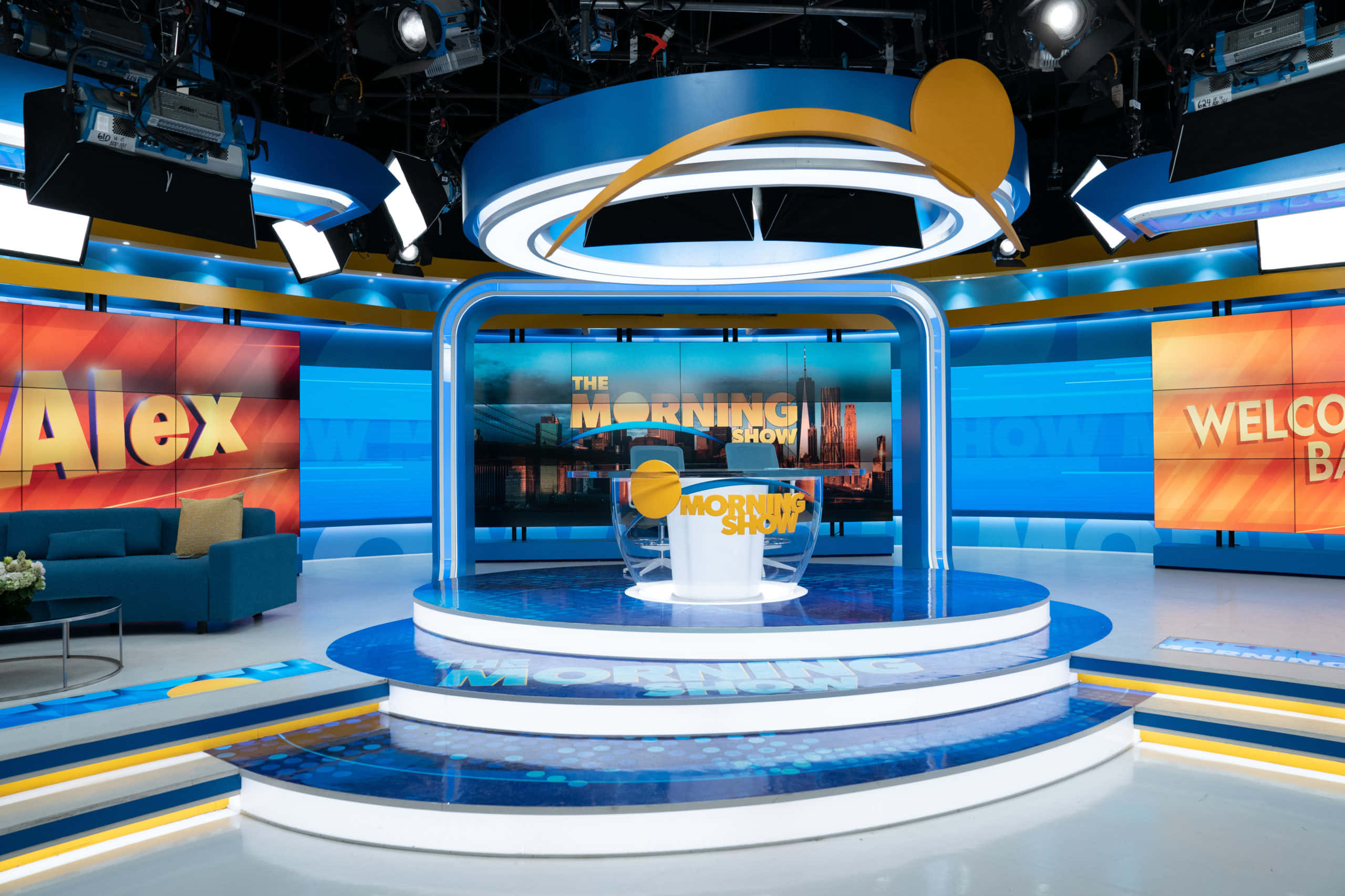 The Morning Show, blue and yellow lighting, central circular desk, 2K Desktop Wallpaper