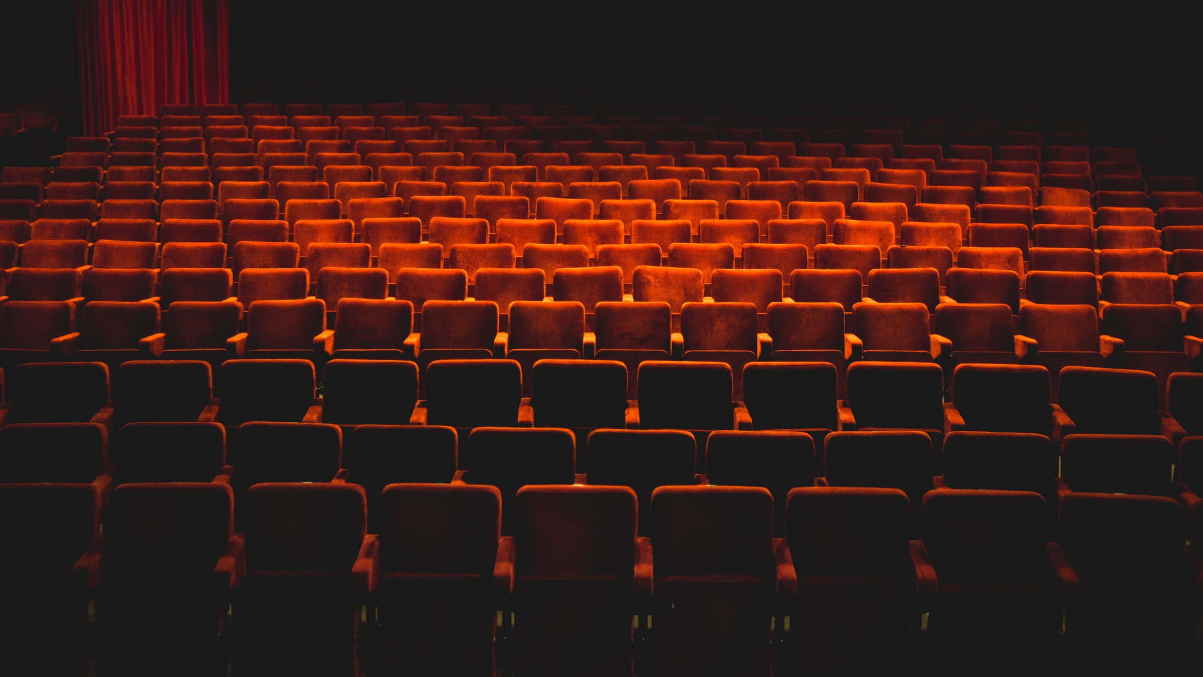 empty theater, red velvet theater seats, dim stage lighting, Full HD Desktop Wallpaper