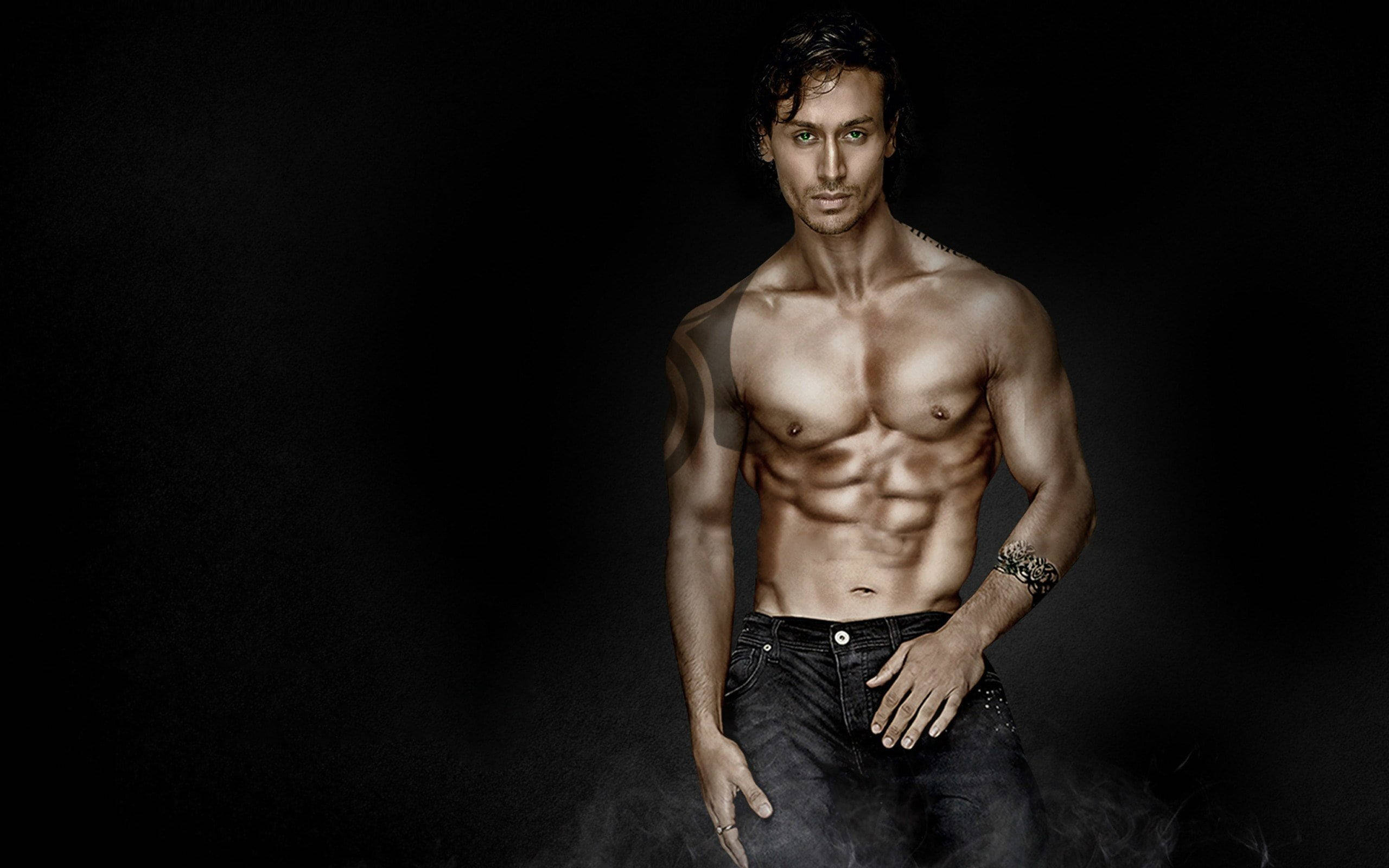 Tiger Shroff, smoky black background, dramatic lighting, 2K Desktop Wallpaper