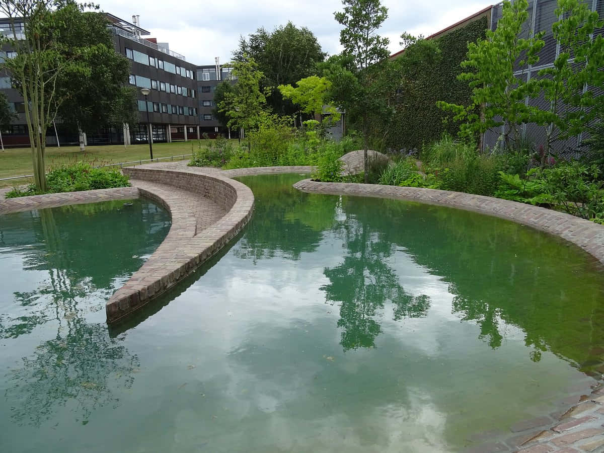 Tilburg, curved brick-edged pond, cloudy skies, SD Desktop Wallpaper