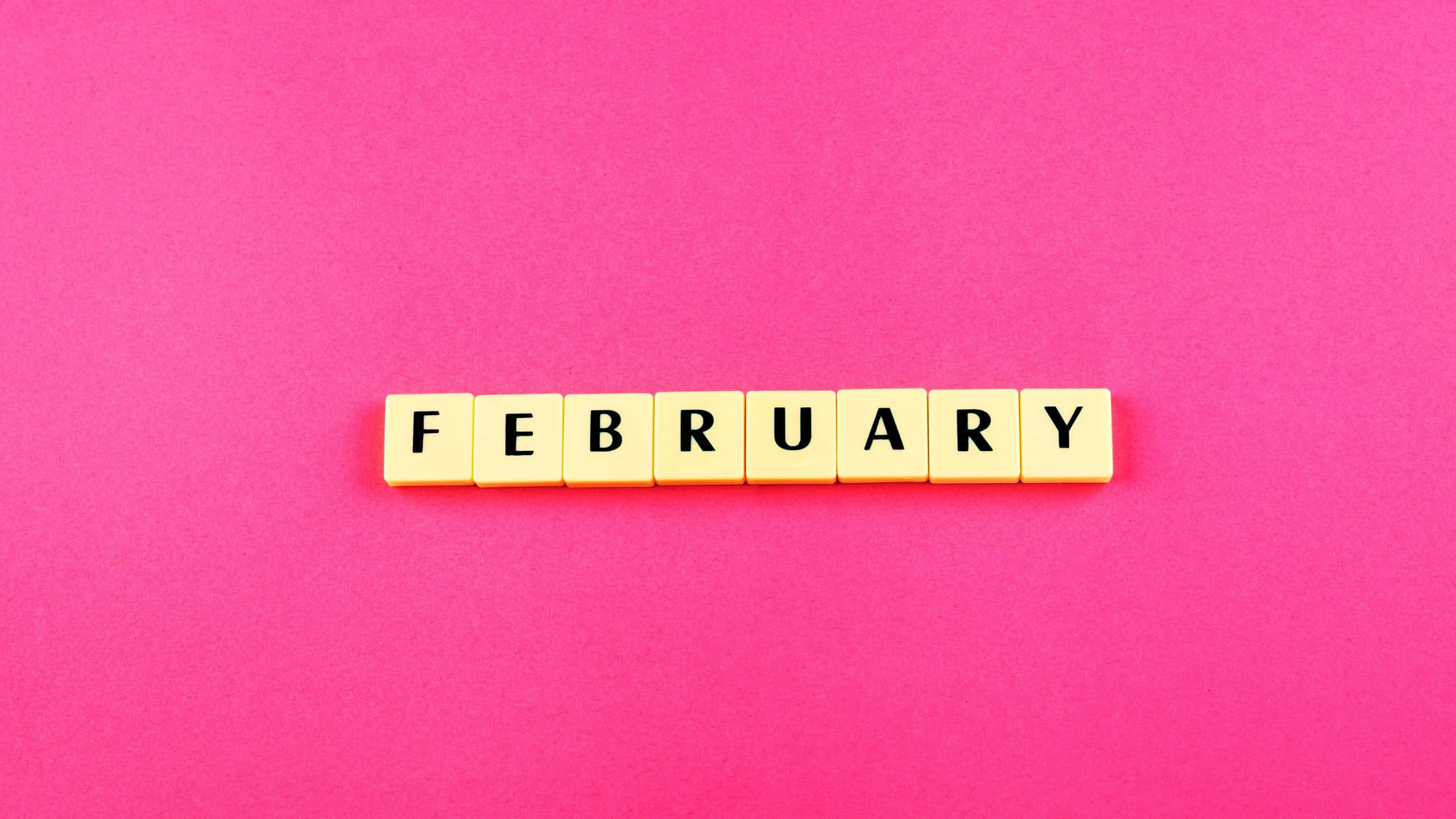 February, yellow letter tiles, vibrant pink background, 2K Desktop Wallpaper