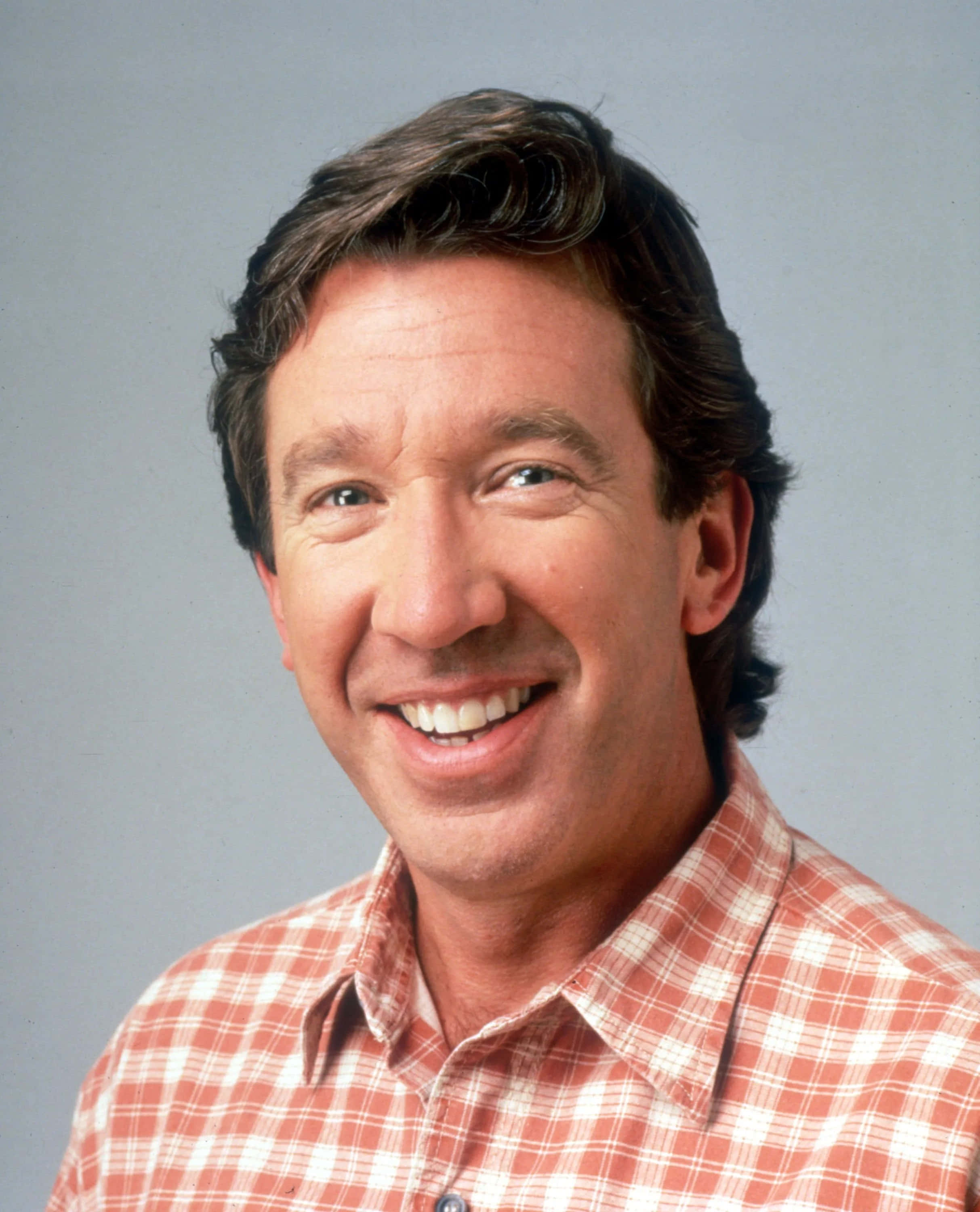 Tim Allen, red and white plaid shirt, gray studio background, 2K Phone Wallpaper