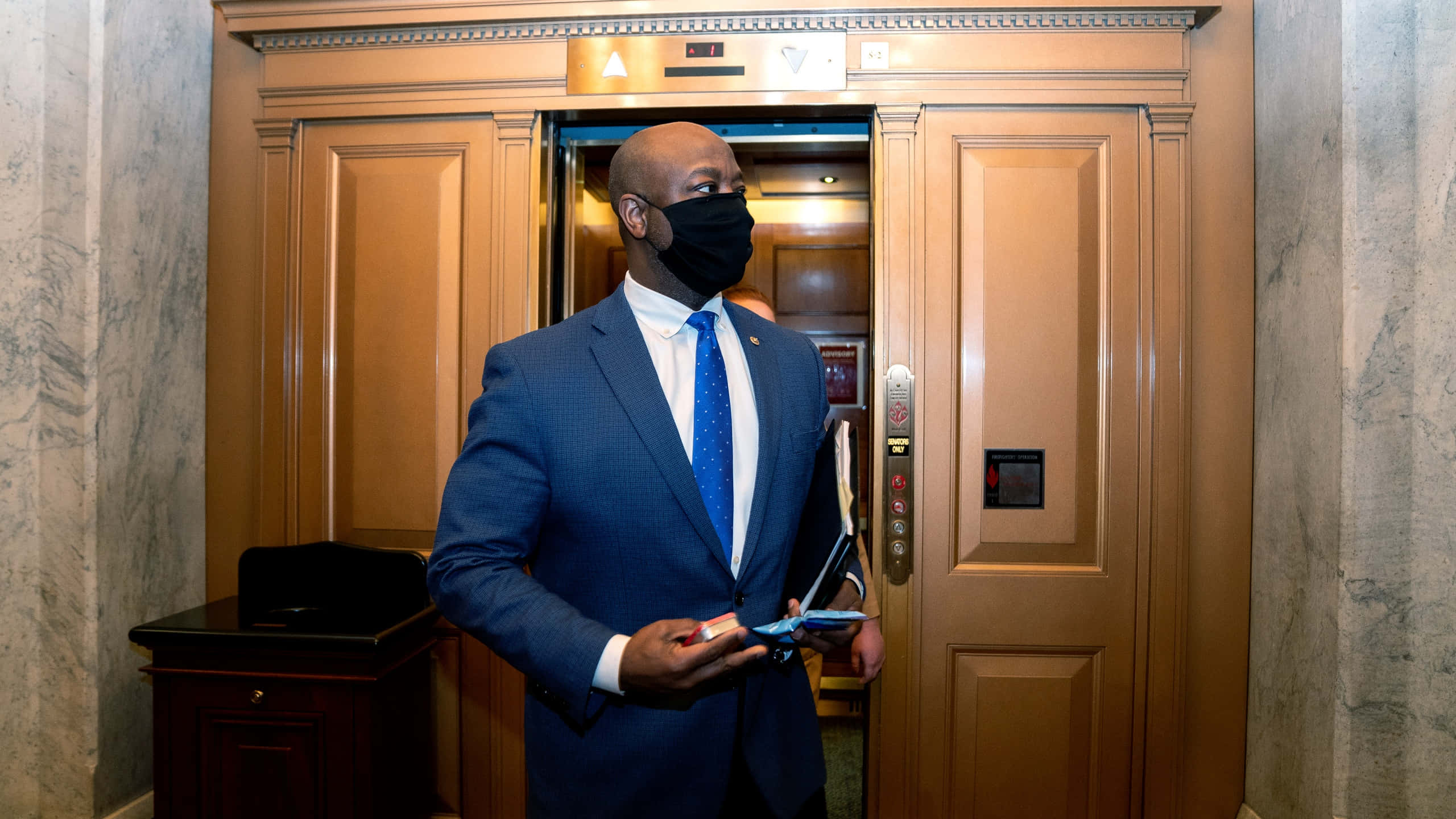 Tim Scott, black face mask, blue suit, 2K Desktop Wallpaper