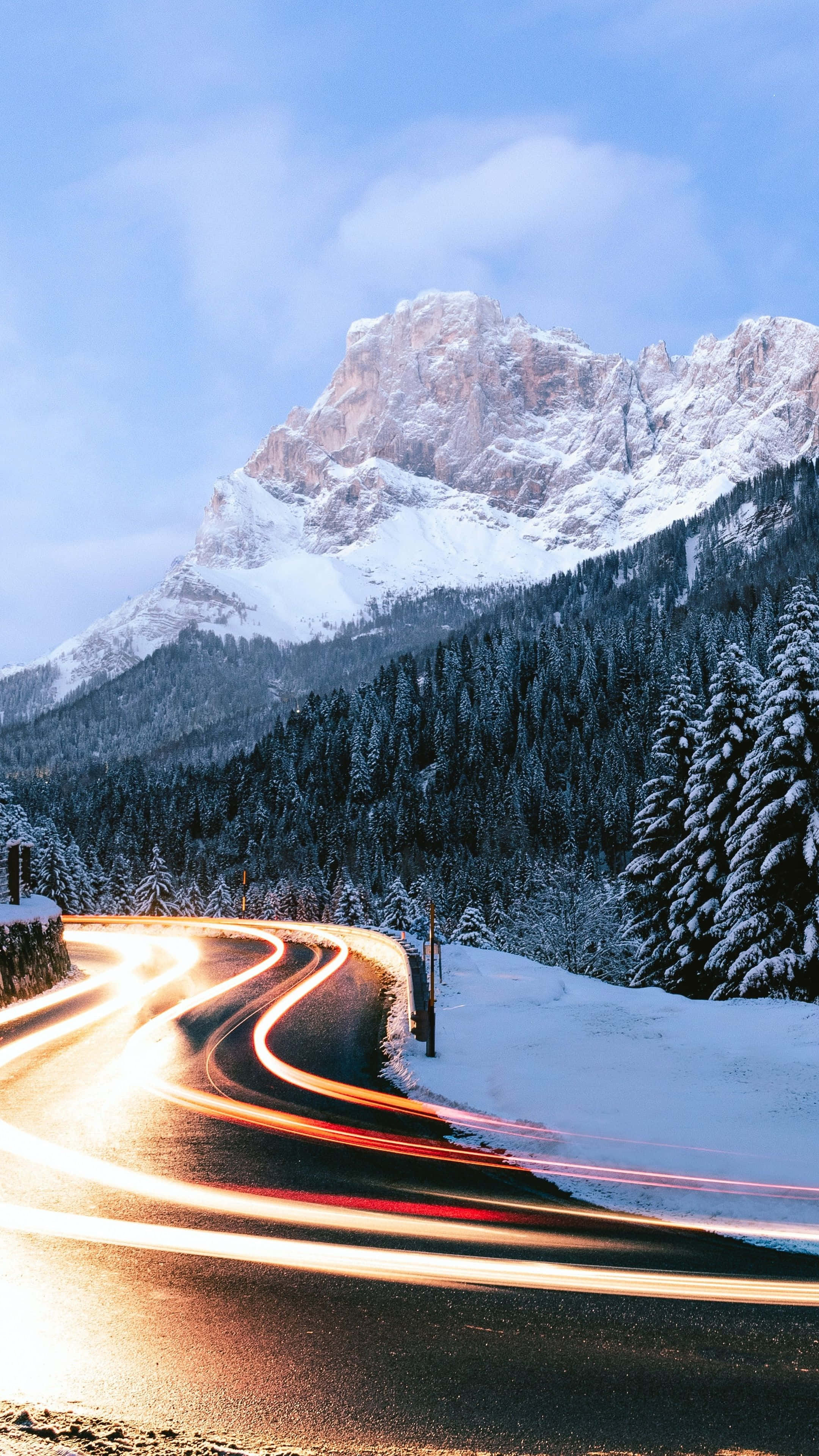 winding road, snowy mountain landscape, light trails from cars, 4K Phone Wallpaper