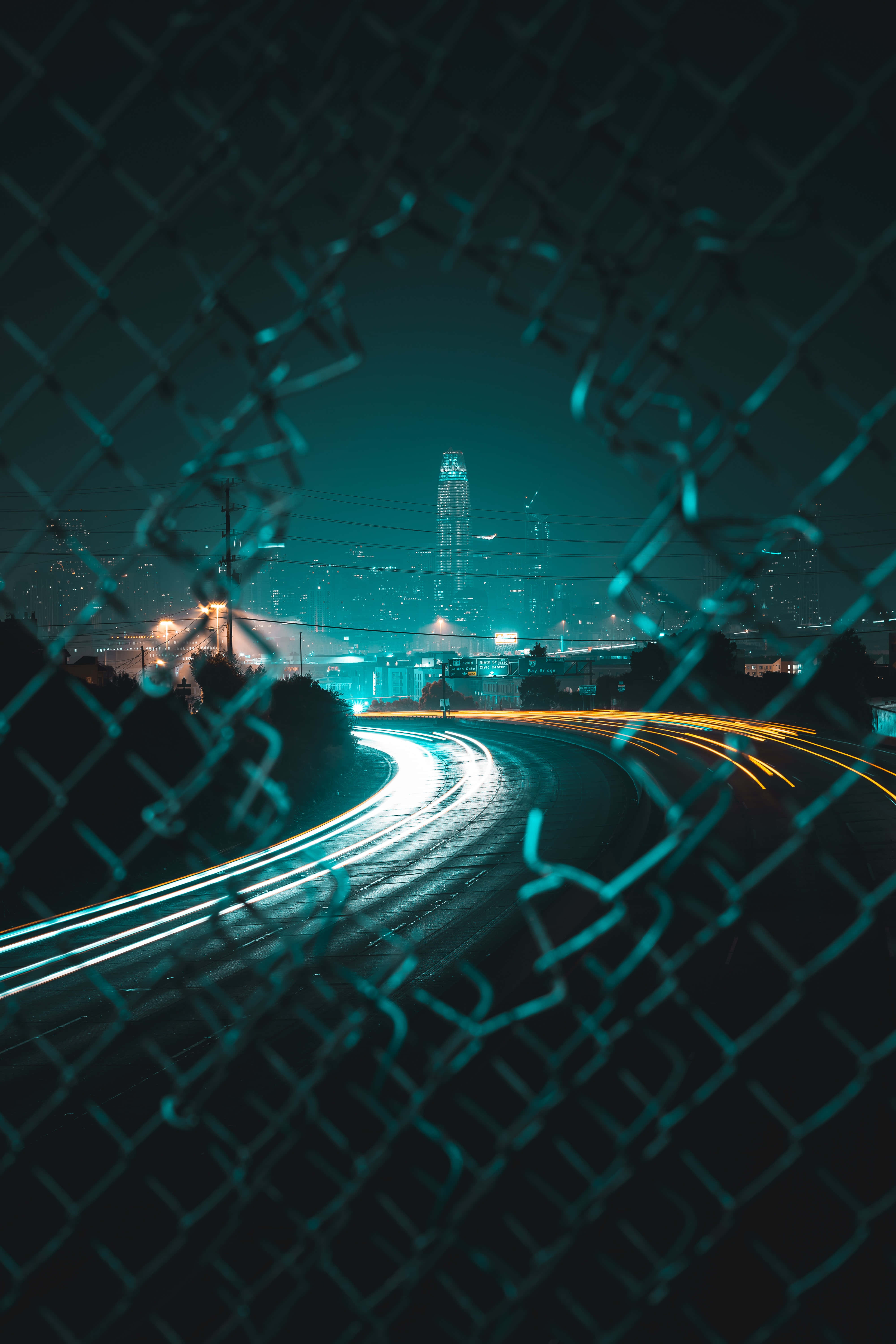 Time lapse, chain-link fence, nighttime cityscape, 5K Phone Wallpaper