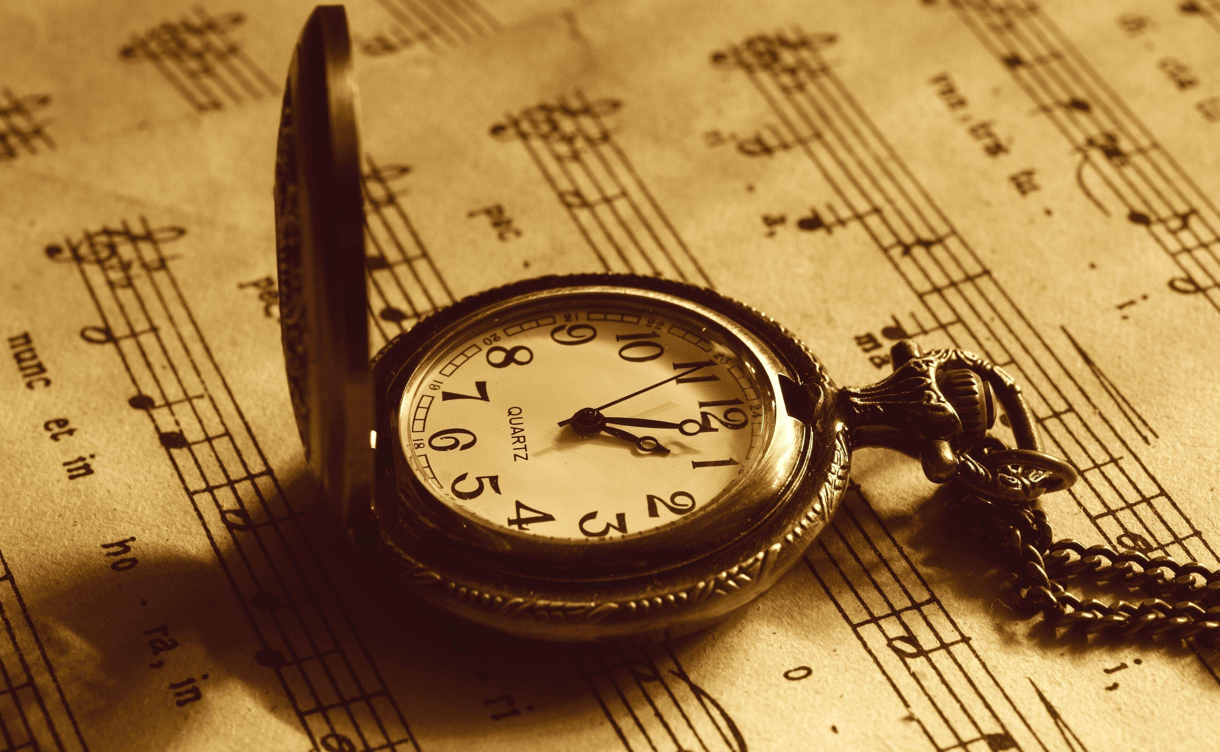 vintage pocket watch, aged sheet music, warm sepia light, 4K Desktop Wallpaper