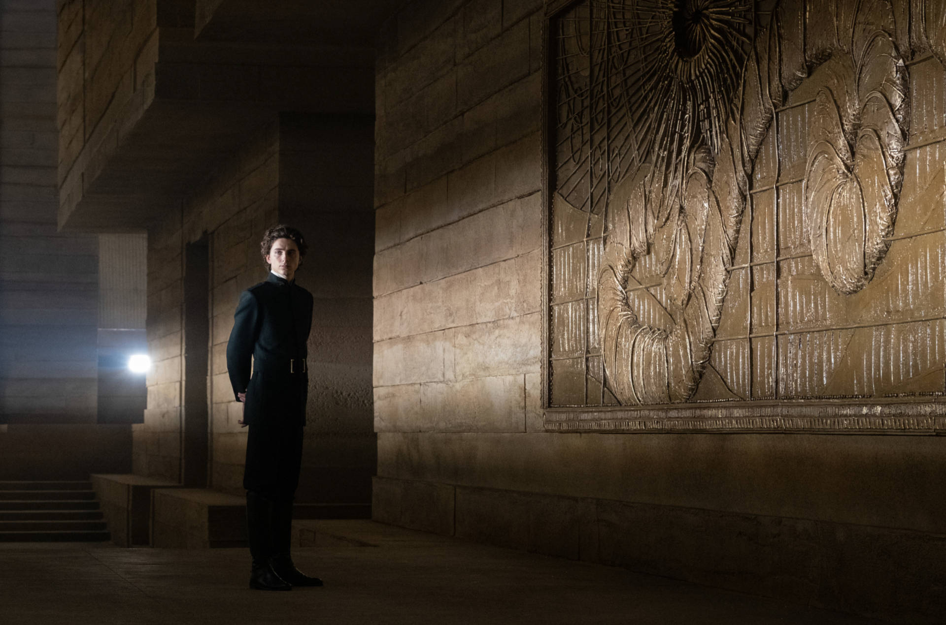 Timothée Chalamet, dark uniform, dimly lit stone corridor, Full HD Desktop Wallpaper