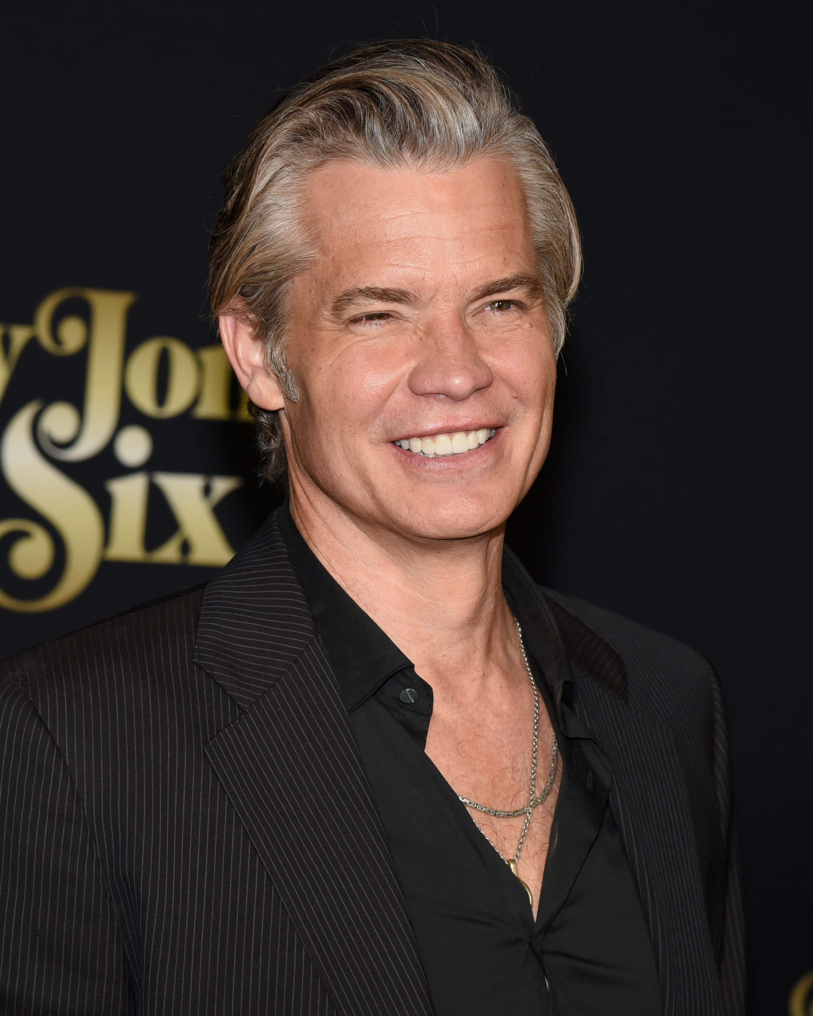 Timothy Olyphant, black pinstripe suit, dark backdrop, 2K Phone Wallpaper