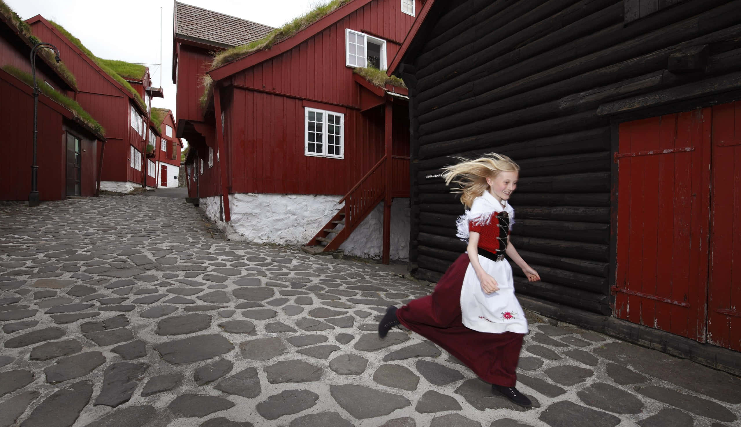Tinganes, red and white attire, cobblestone street, 2K Desktop Wallpaper