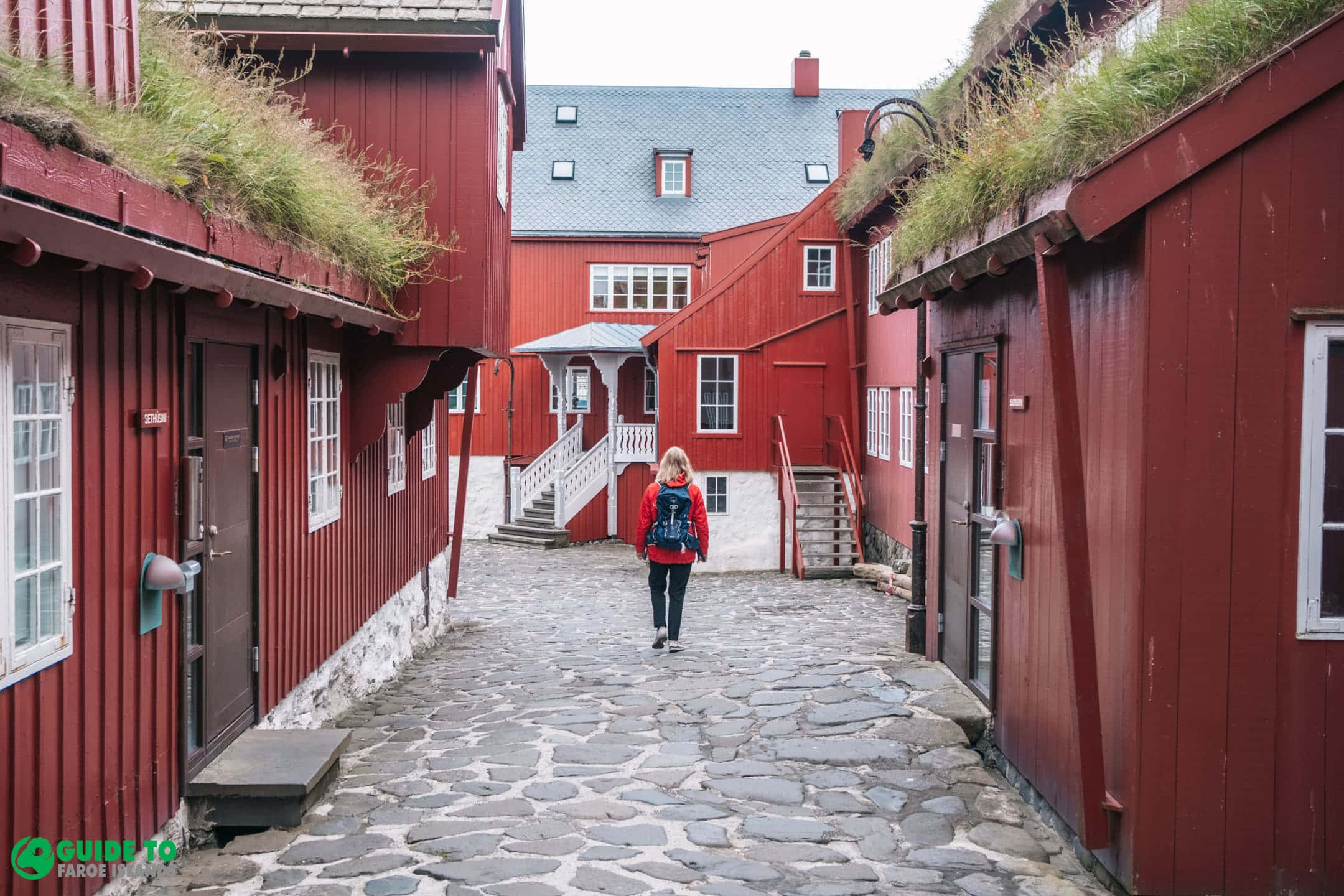 Tinganes, red jacket, cobblestone alley, Full HD Desktop Wallpaper