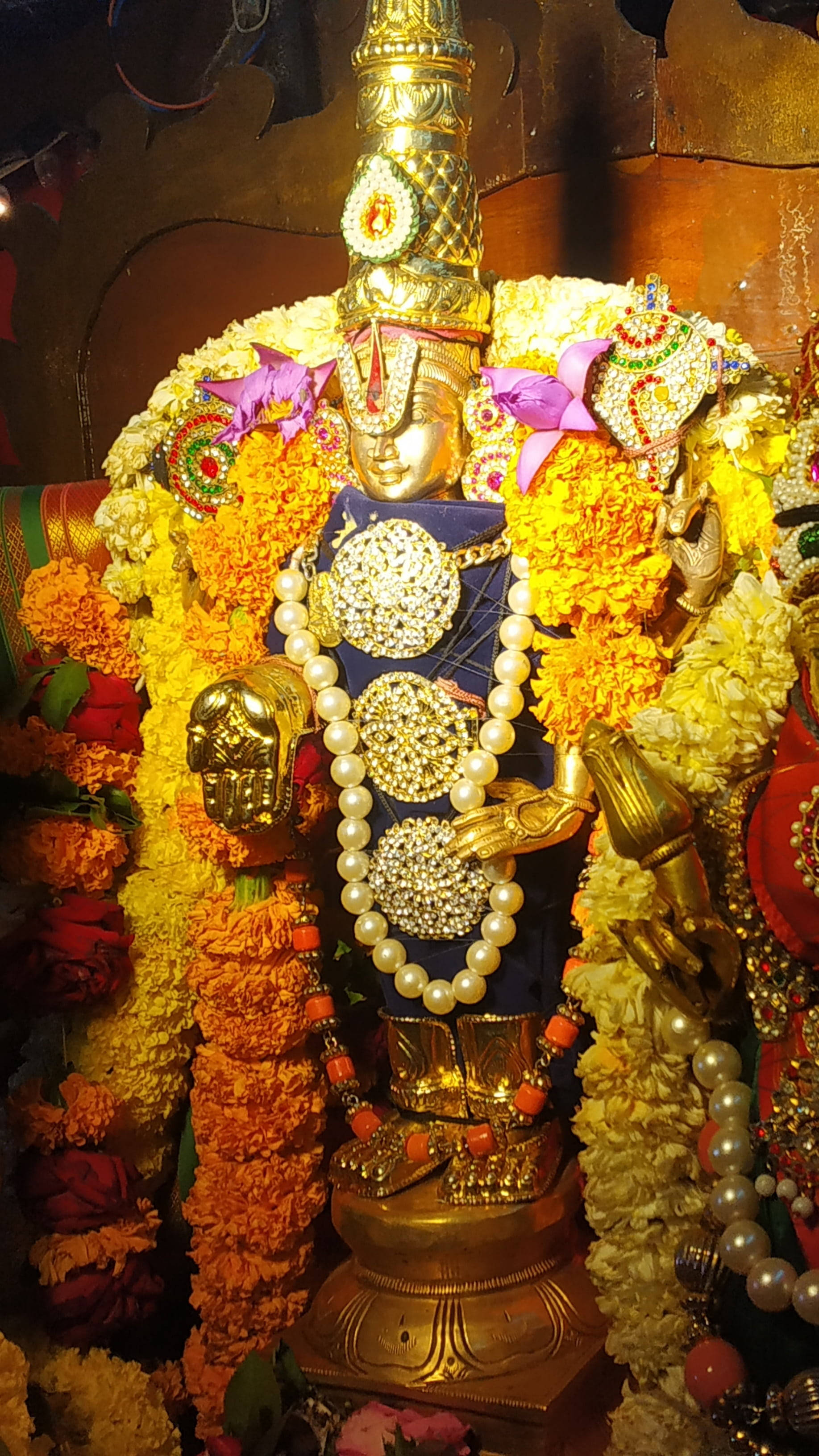 Tirupati Balaji, golden deity statue, marigold garlands, 2K Phone Wallpaper