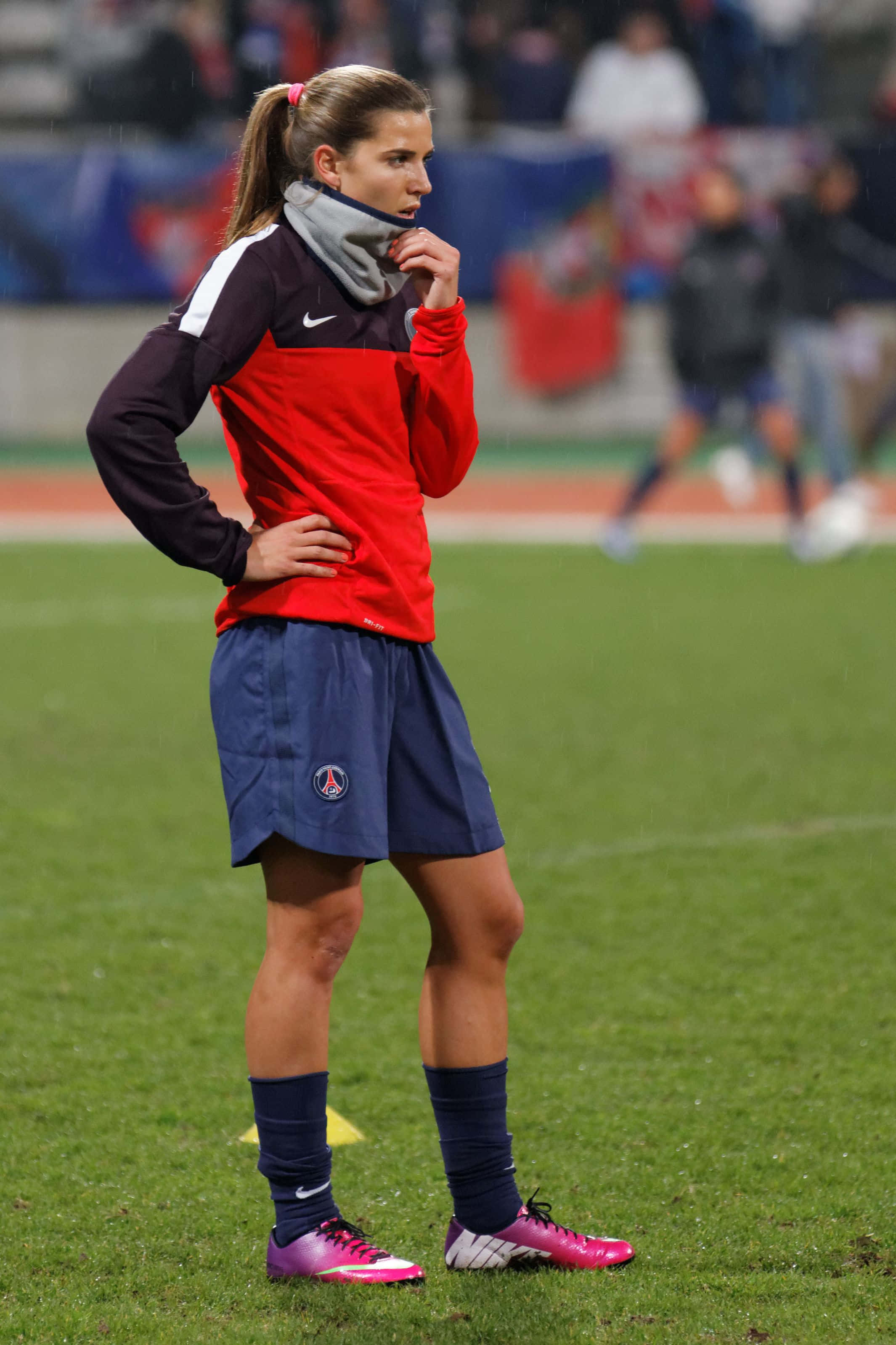 Tobin Heath, red and blue training gear, rain-slicked grass field, 2K Phone Wallpaper