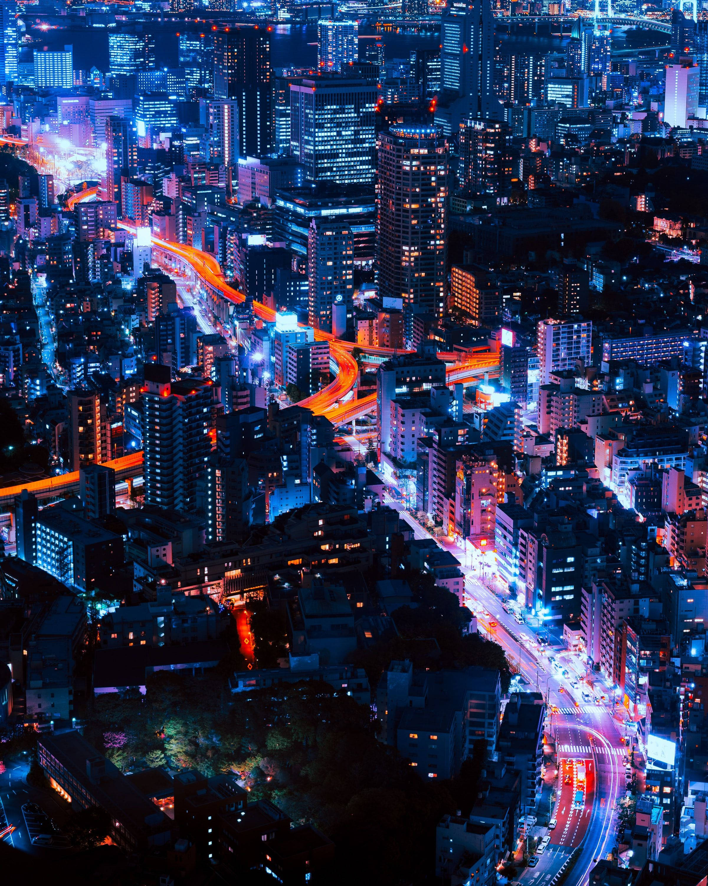 Tokyo, neon-lit cityscape, glowing blue skyscrapers, 2K Phone Wallpaper