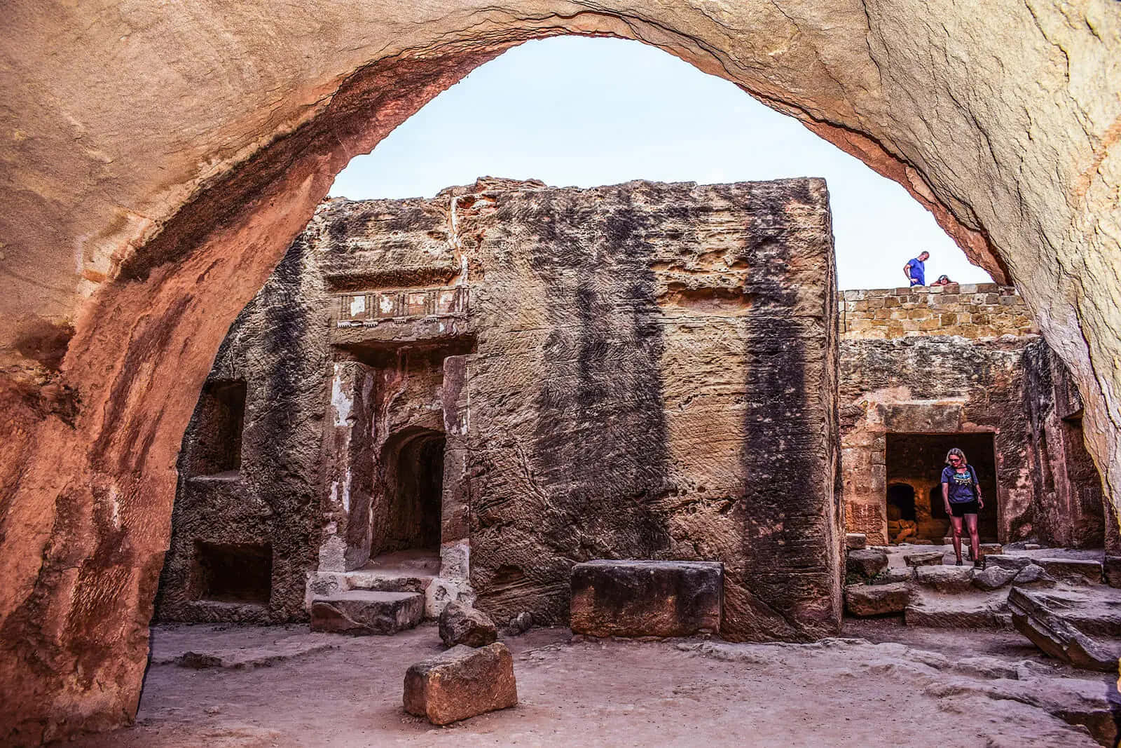 ancient tomb interior, sunlit rock-cut temple complex, massive natural sandstone archway, HD Desktop Wallpaper