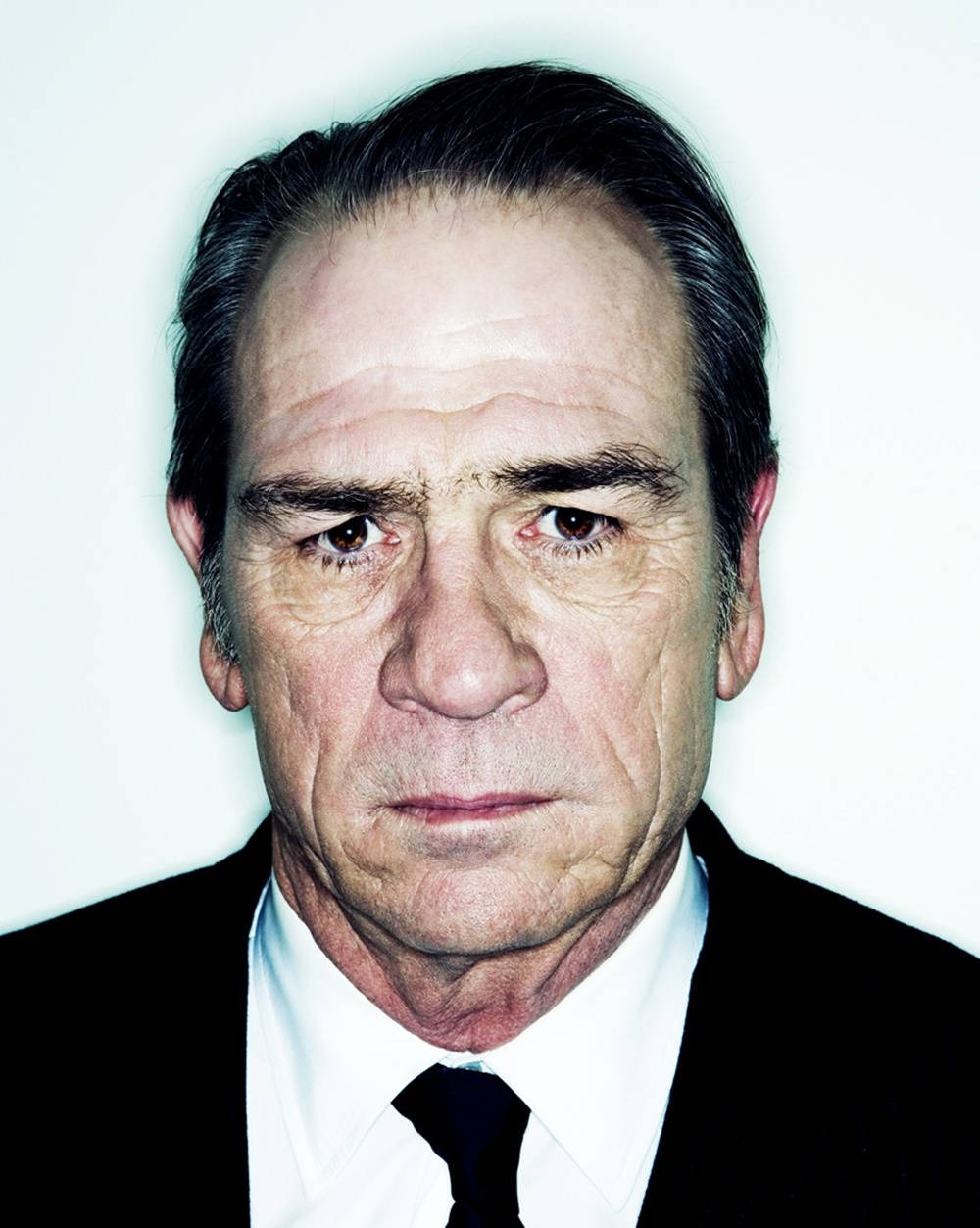 Tommy Lee Jones, black suit and tie, stark white background, SD Phone Wallpaper