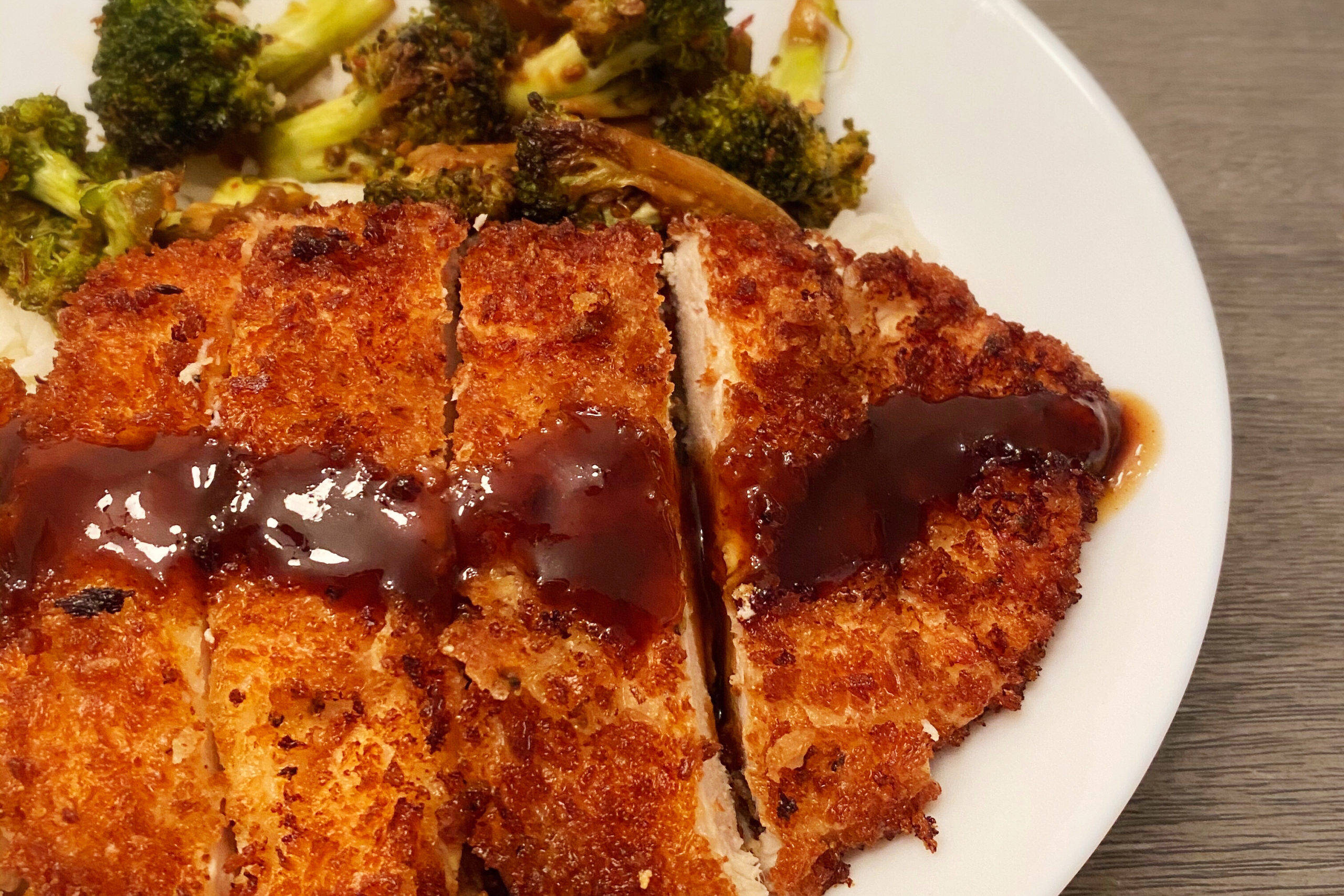 boneless panko crusted tonkatsu, golden-brown breaded chicken cutlet, glossy dark sauce, 2K Desktop Wallpaper