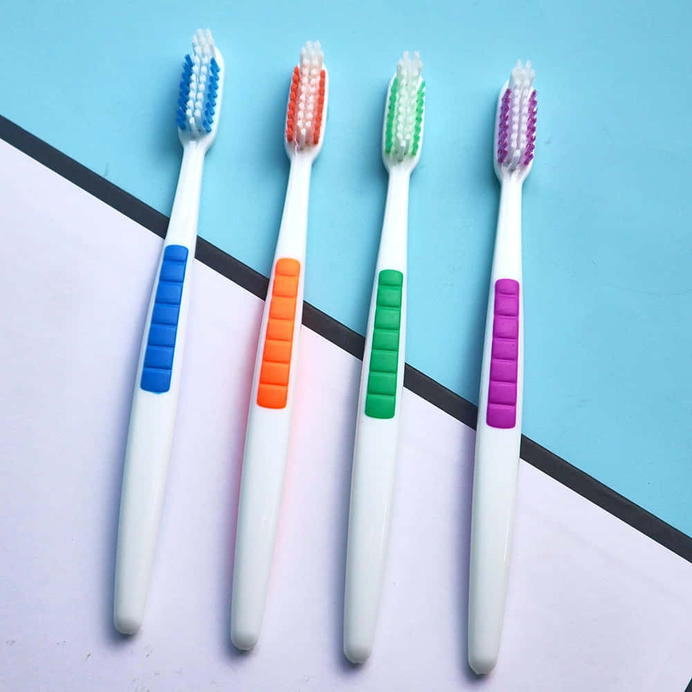 colorful toothbrushes, blue orange green purple grips, blue and white geometric background, SD Desktop Wallpaper