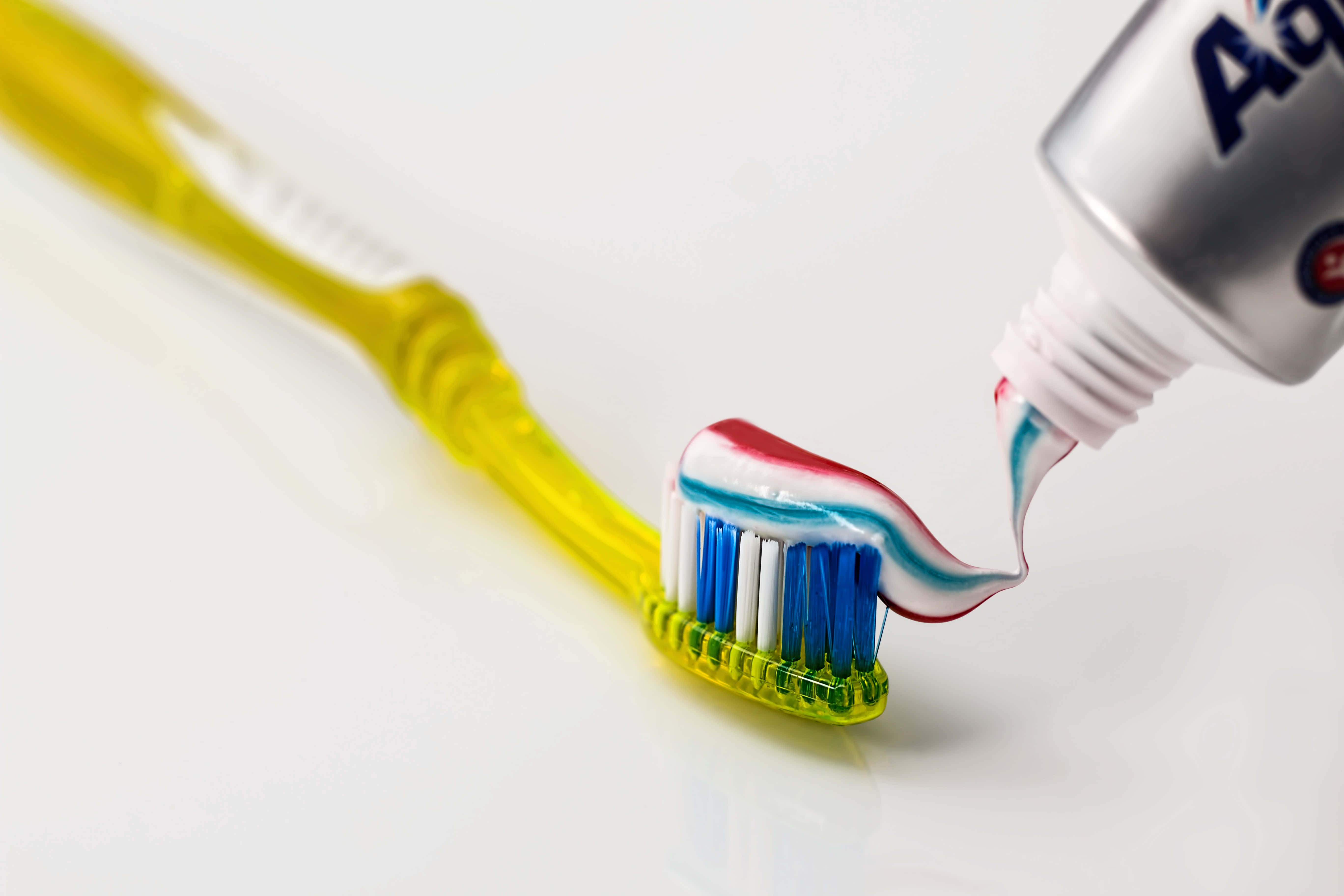 yellow toothbrush, red white and blue toothpaste, clean white background, 5K Desktop Wallpaper