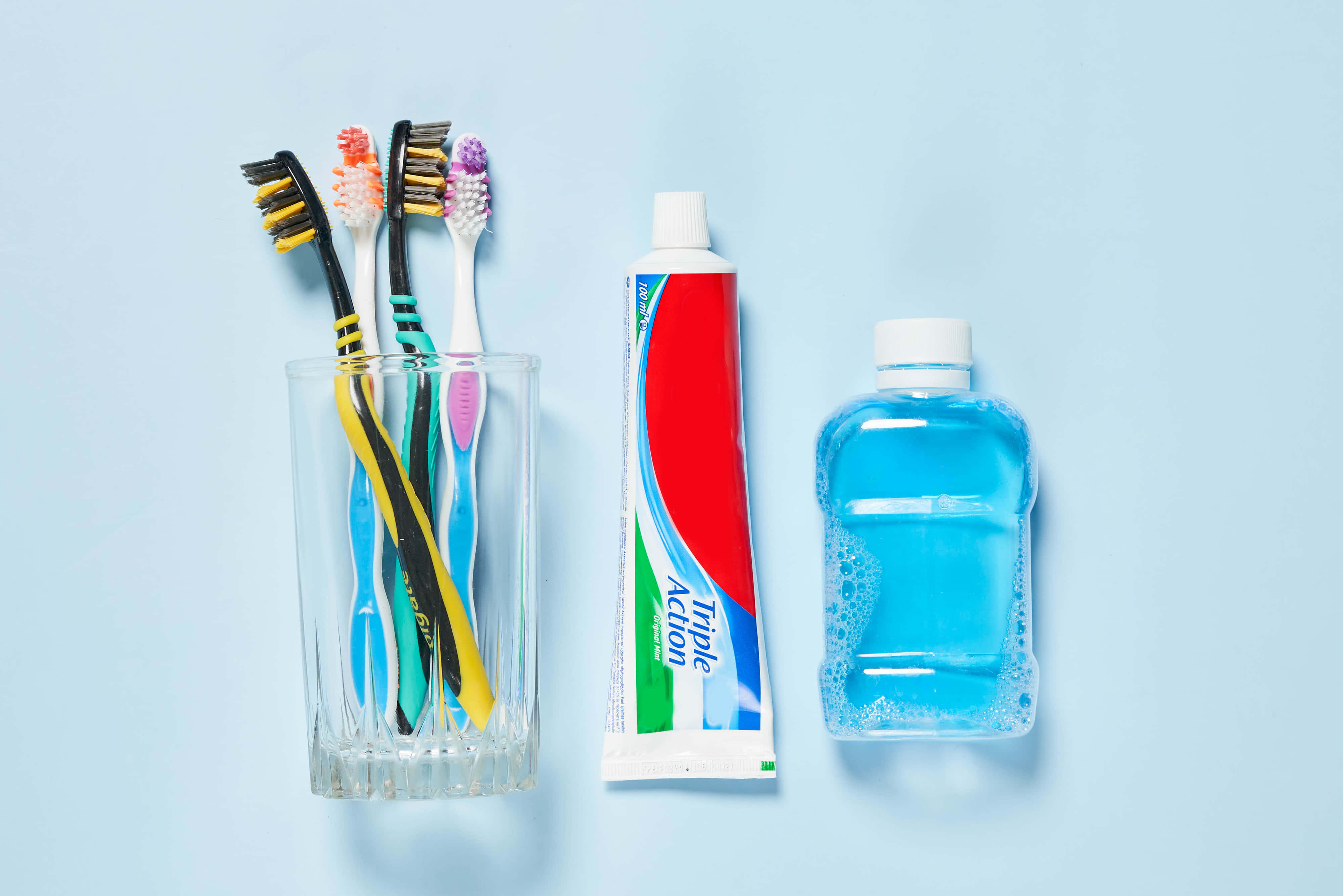 dental care essentials, blue background, colorful toothbrushes, 4K Desktop Wallpaper