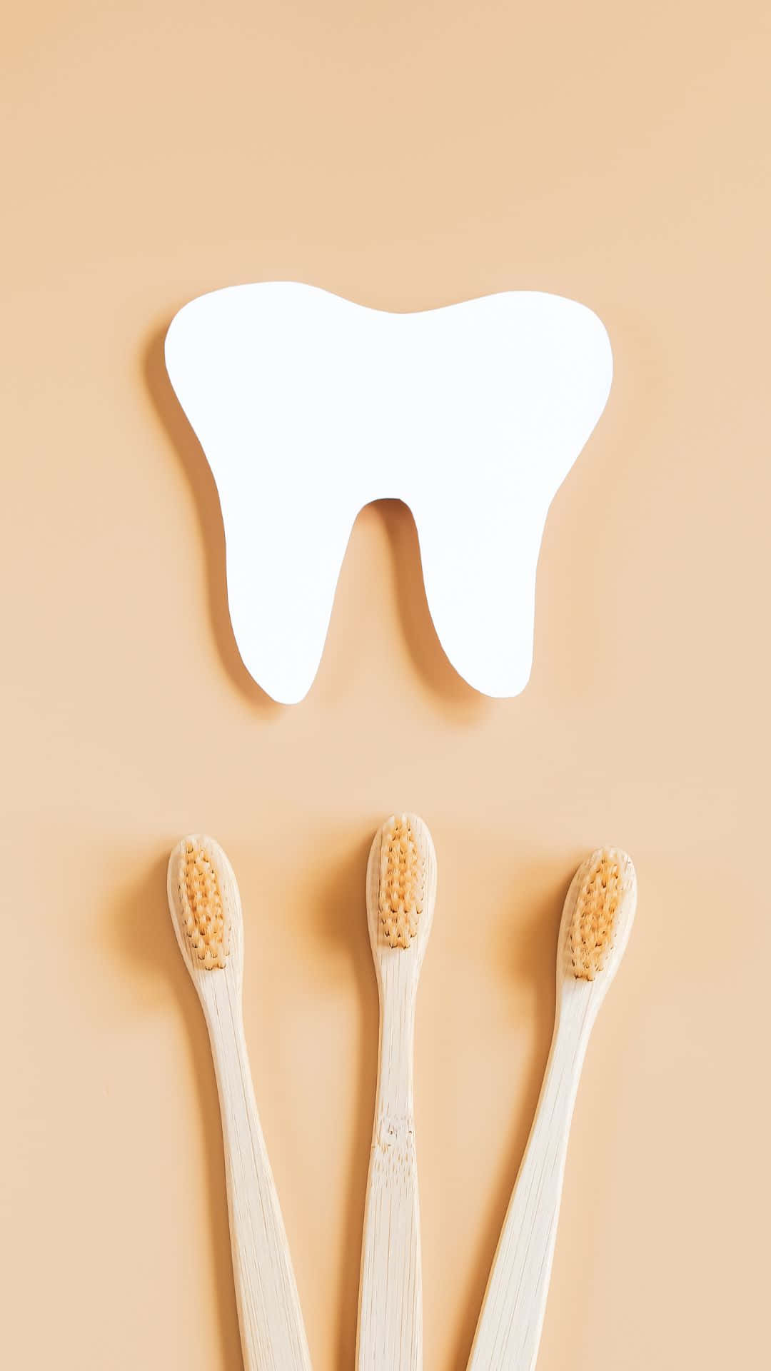bamboo toothbrushes, white tooth-shaped cutout, soft peach background, Full HD Phone Wallpaper