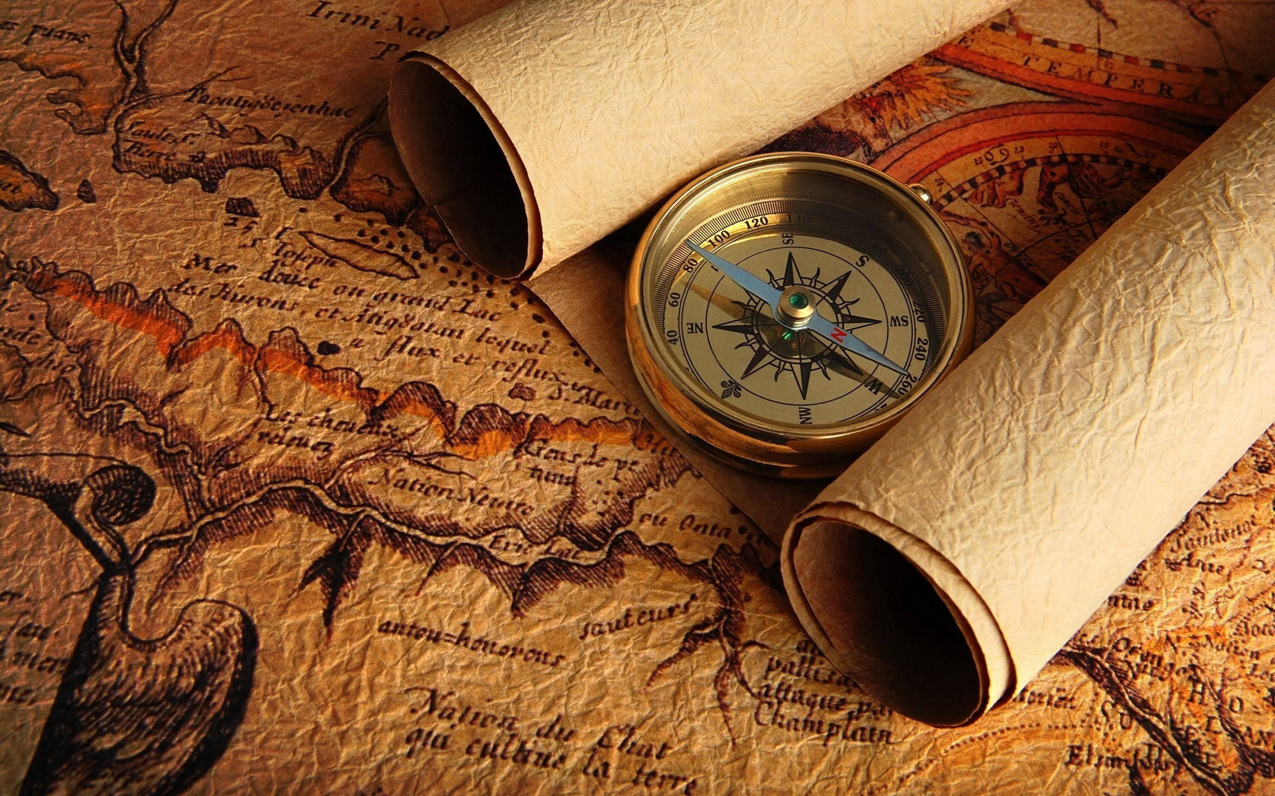 brass compass, aged parchment map, rolled scrolls, 2K Desktop Wallpaper