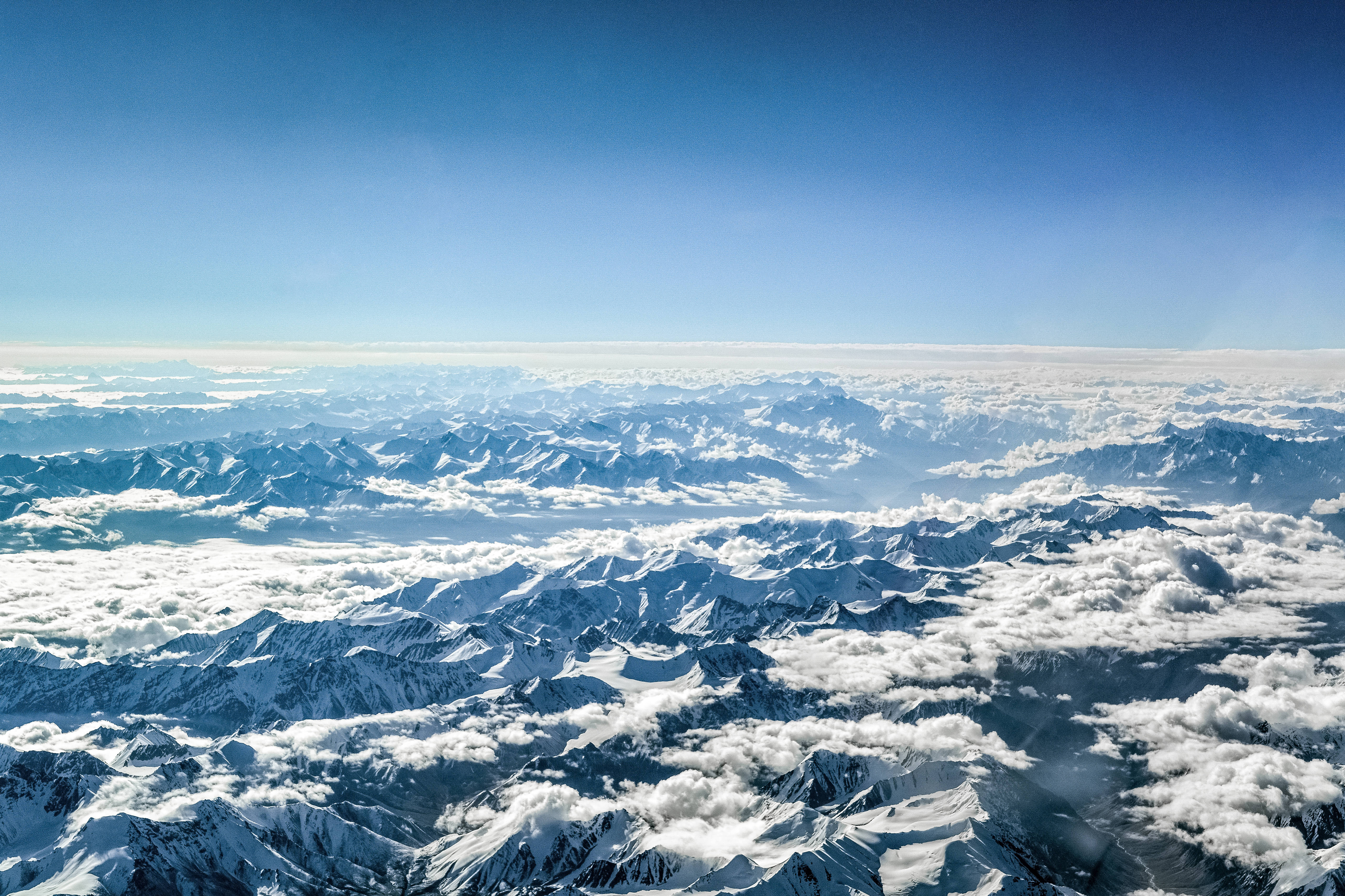 cloudy mountain topography, snowcapped mountain peaks, fluffy white clouds, 5K Desktop Wallpaper