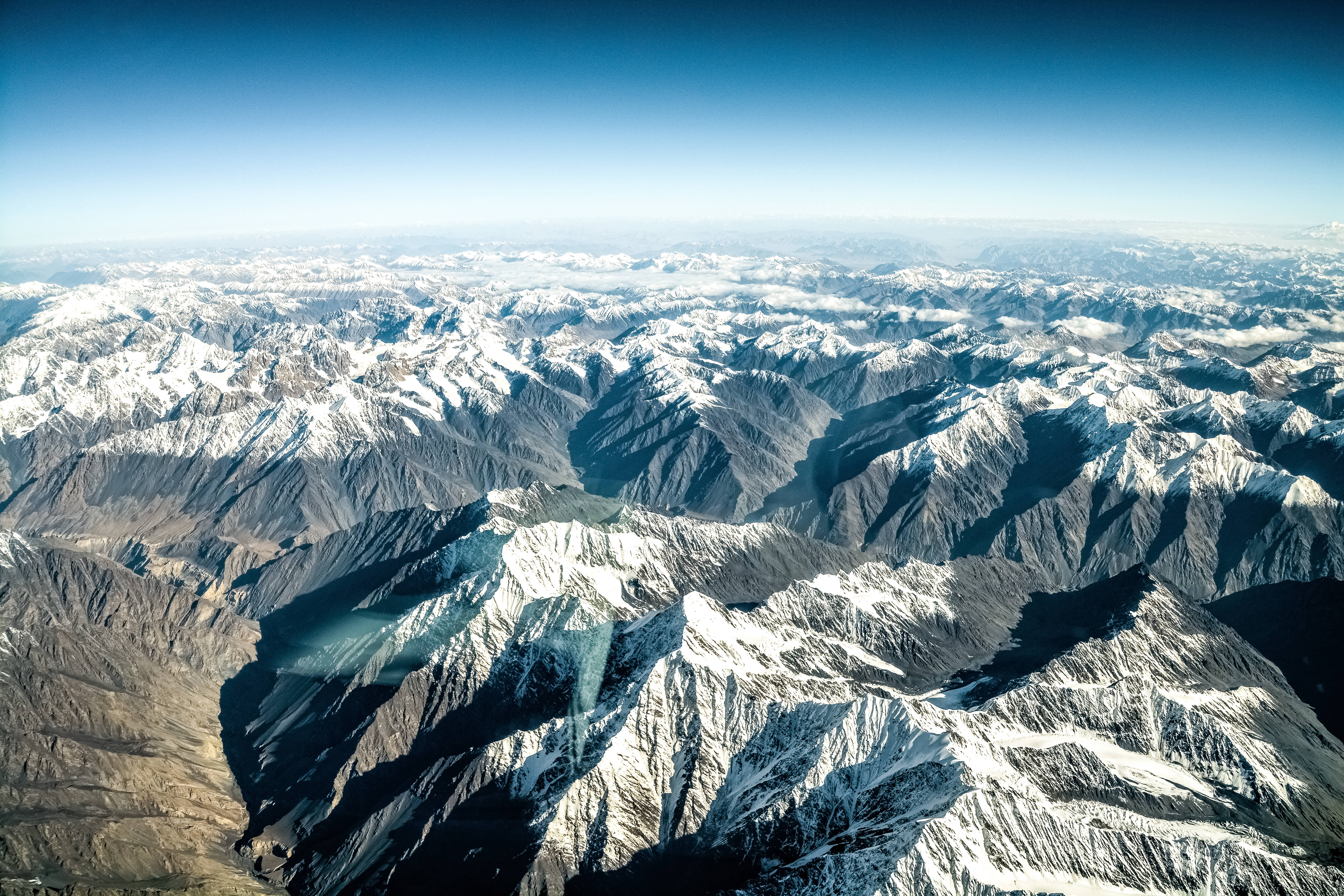 snowcapped mountain ranges, clear blue sky, deep shadows in valleys, 5K Desktop Wallpaper