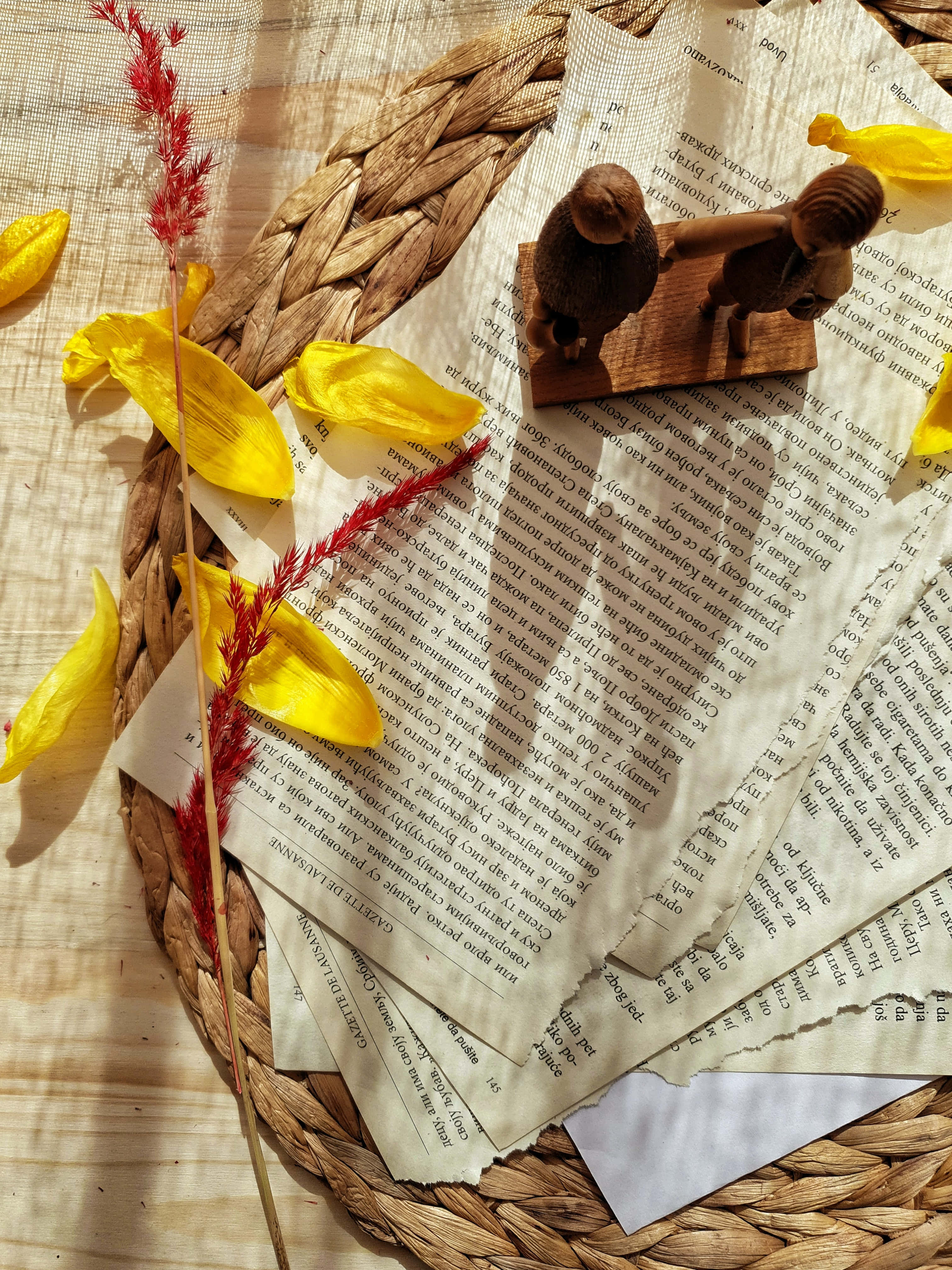 Sunlit woven basket, vintage book pages, yellow petals, 4K Phone Wallpaper