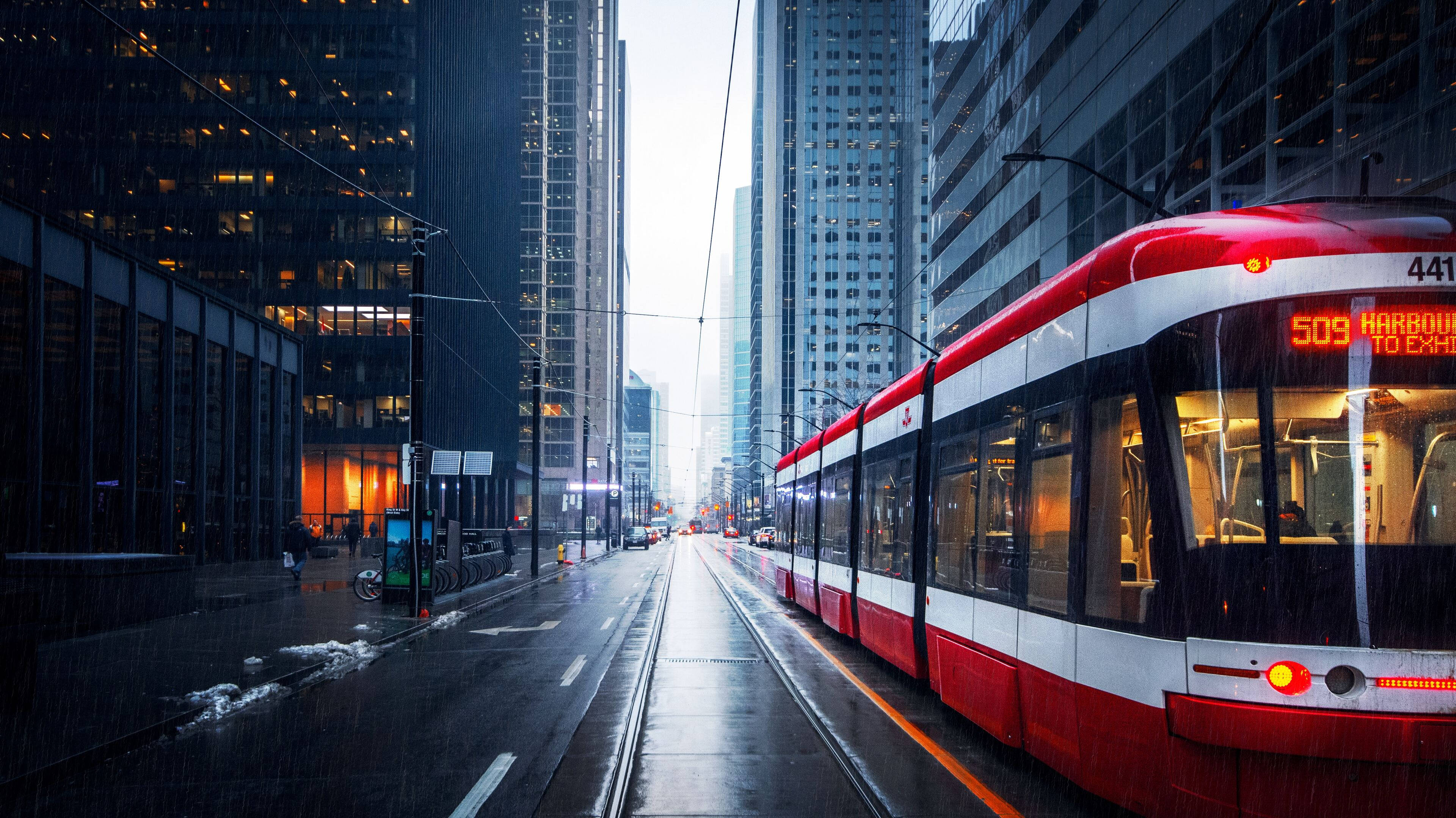 Toronto, red and white streetcar, rain-slicked urban canyon, 4K Desktop Wallpaper