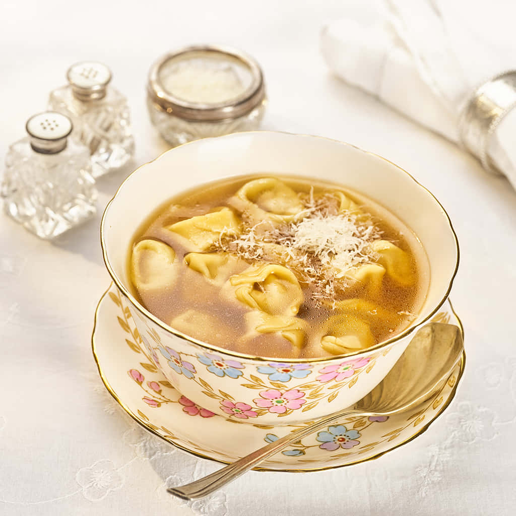 tortellini in brodo, steaming bowl, floral-patterned saucer, SD Desktop Wallpaper