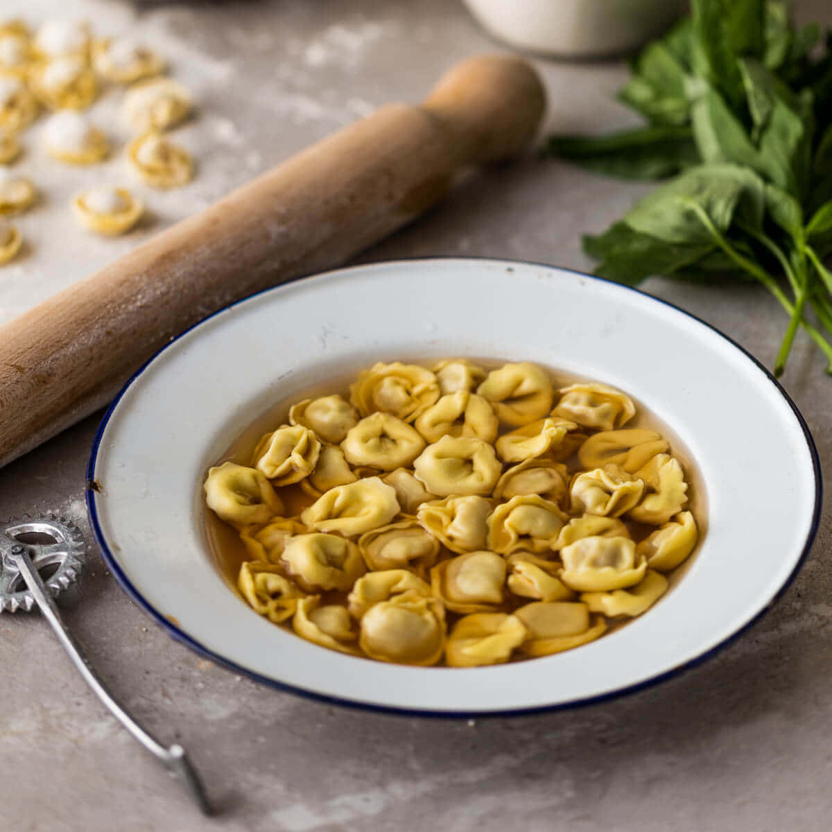 Tortellini In Brodo, bowl of golden tortellini in broth, wooden rolling pin, SD Desktop Wallpaper