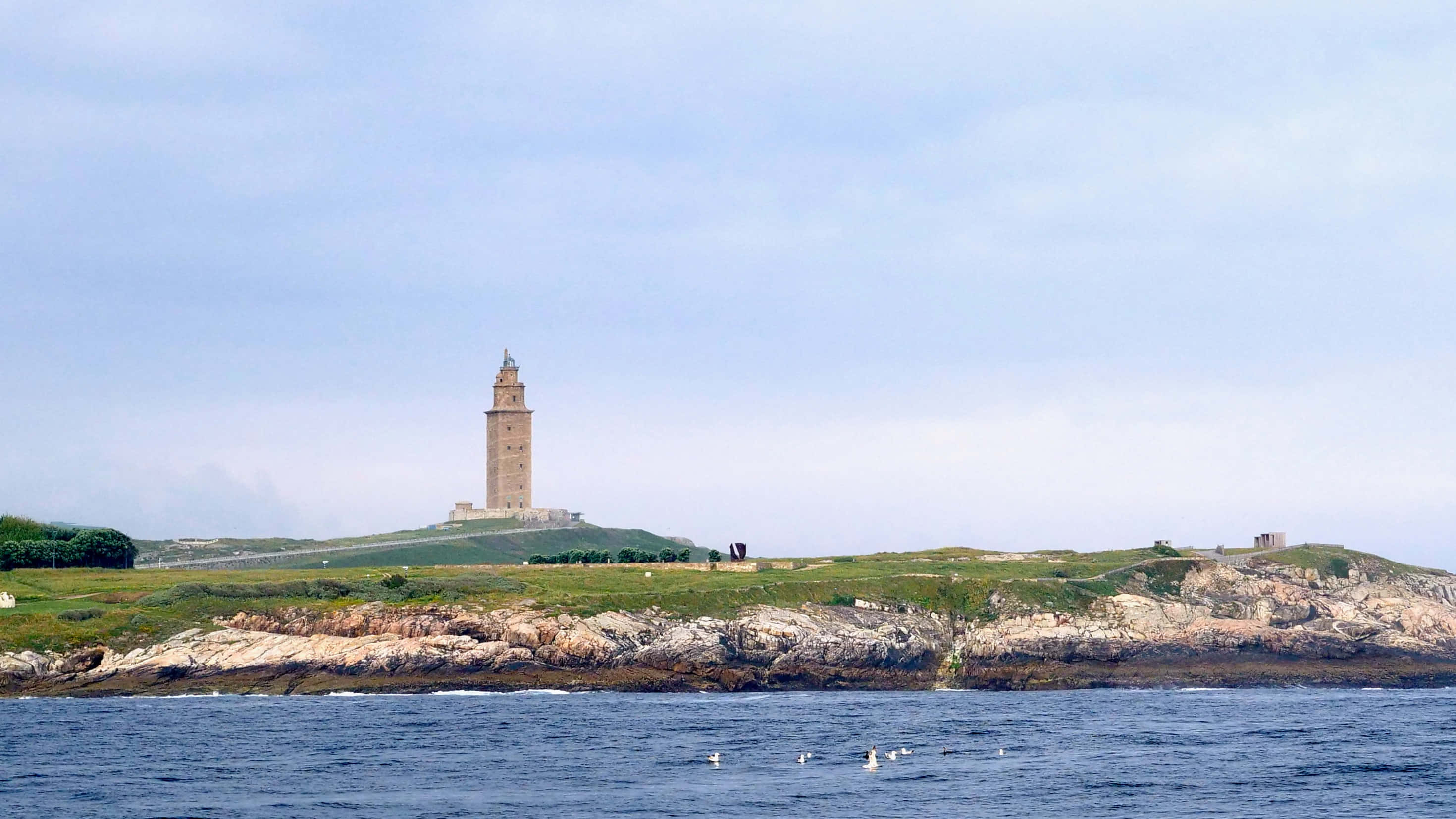Tower Of Hercules, ocean, grassy coastal hill, 2K Desktop Wallpaper
