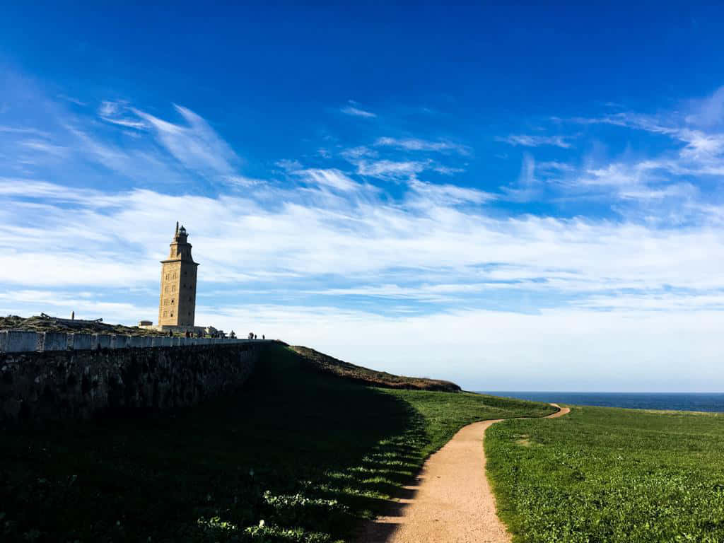 Tower Of Hercules, grassy cliff, winding dirt path, SD Desktop Wallpaper