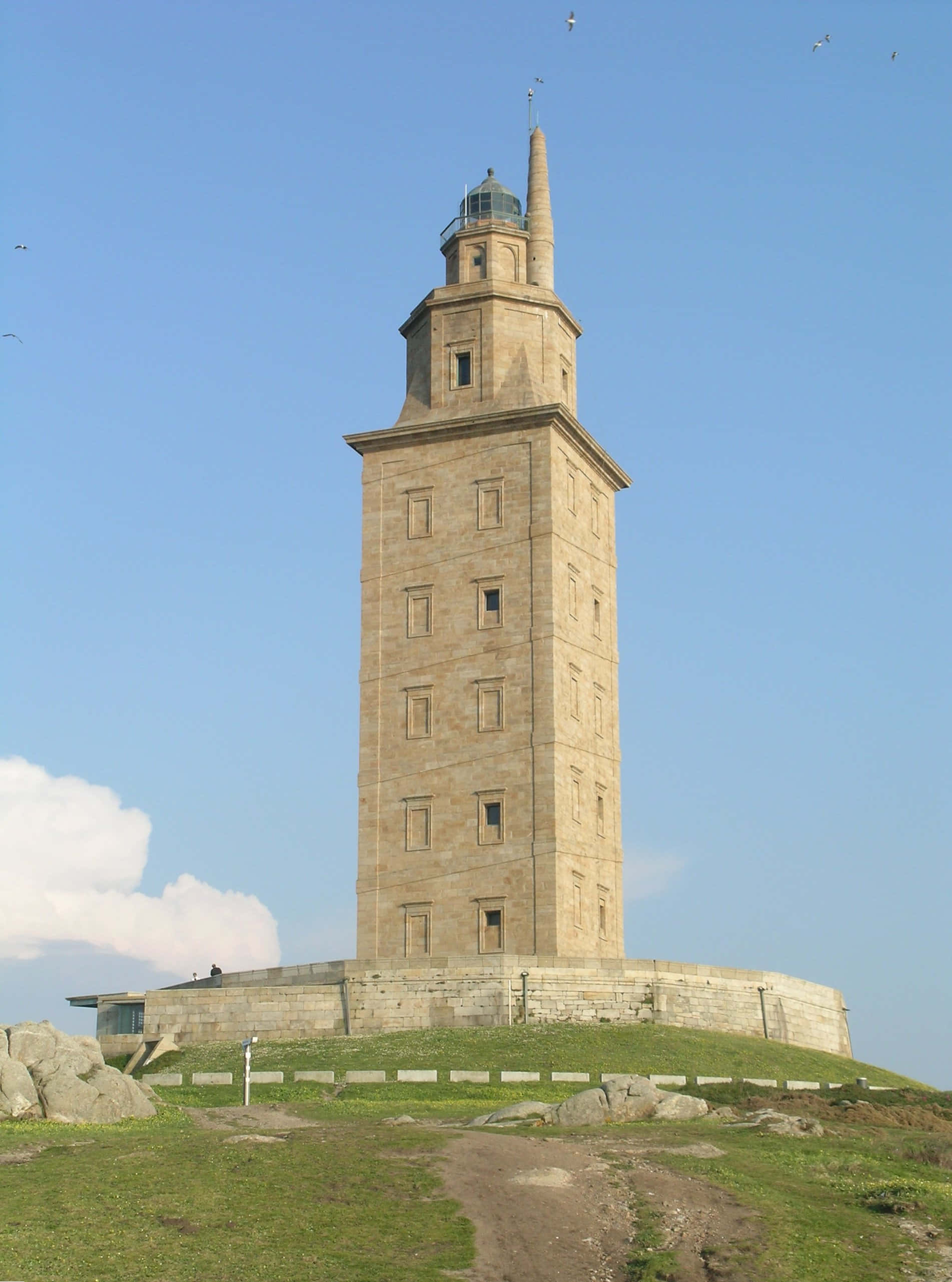 Tower Of Hercules, stone lighthouse, grassy cliff, 2K Phone Wallpaper