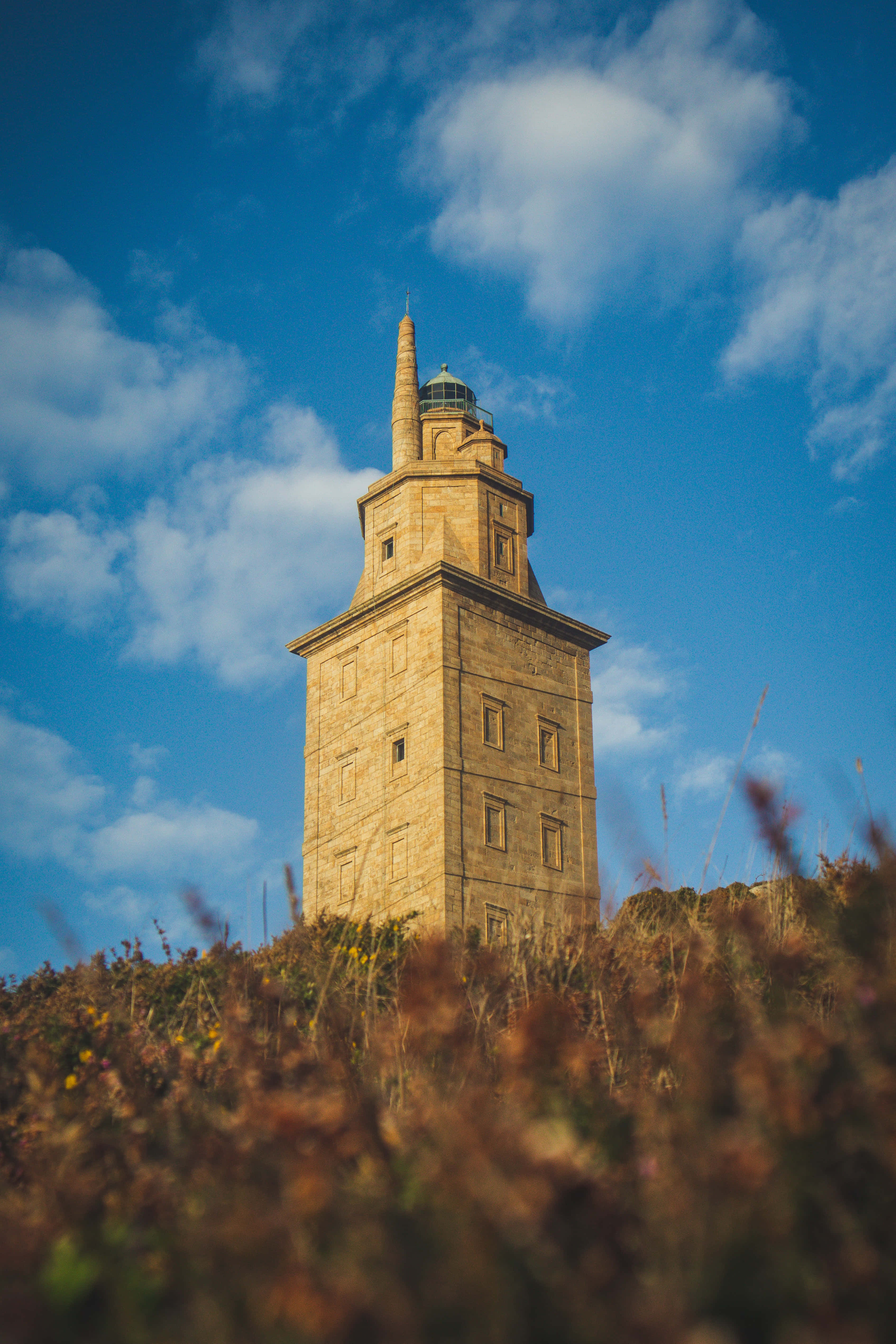 Tower Of Hercules, stone lighthouse, grassy hill, 4K Phone Wallpaper