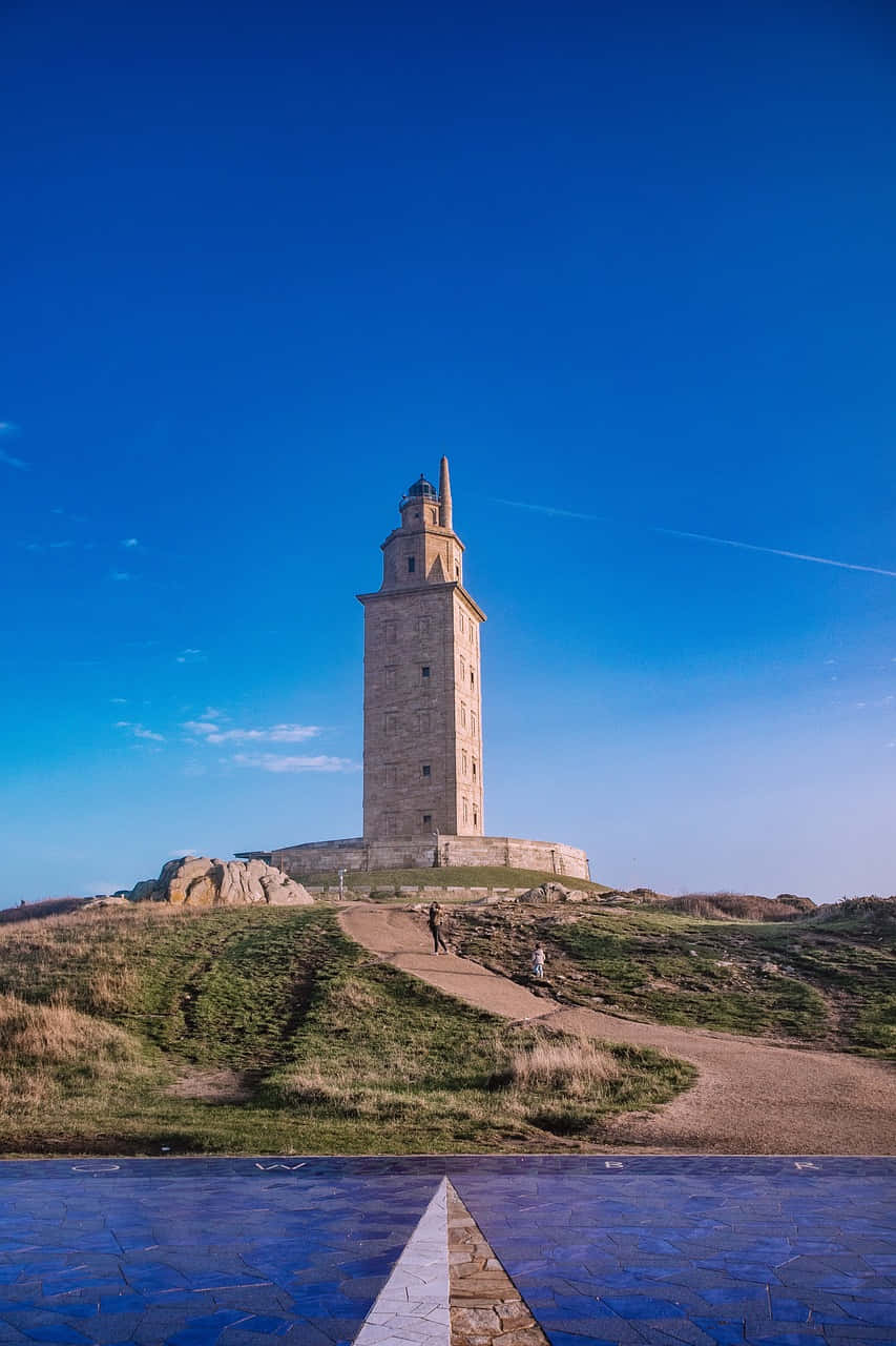 Tower Of Hercules, grassy hill, clear blue sky, HD Phone Wallpaper