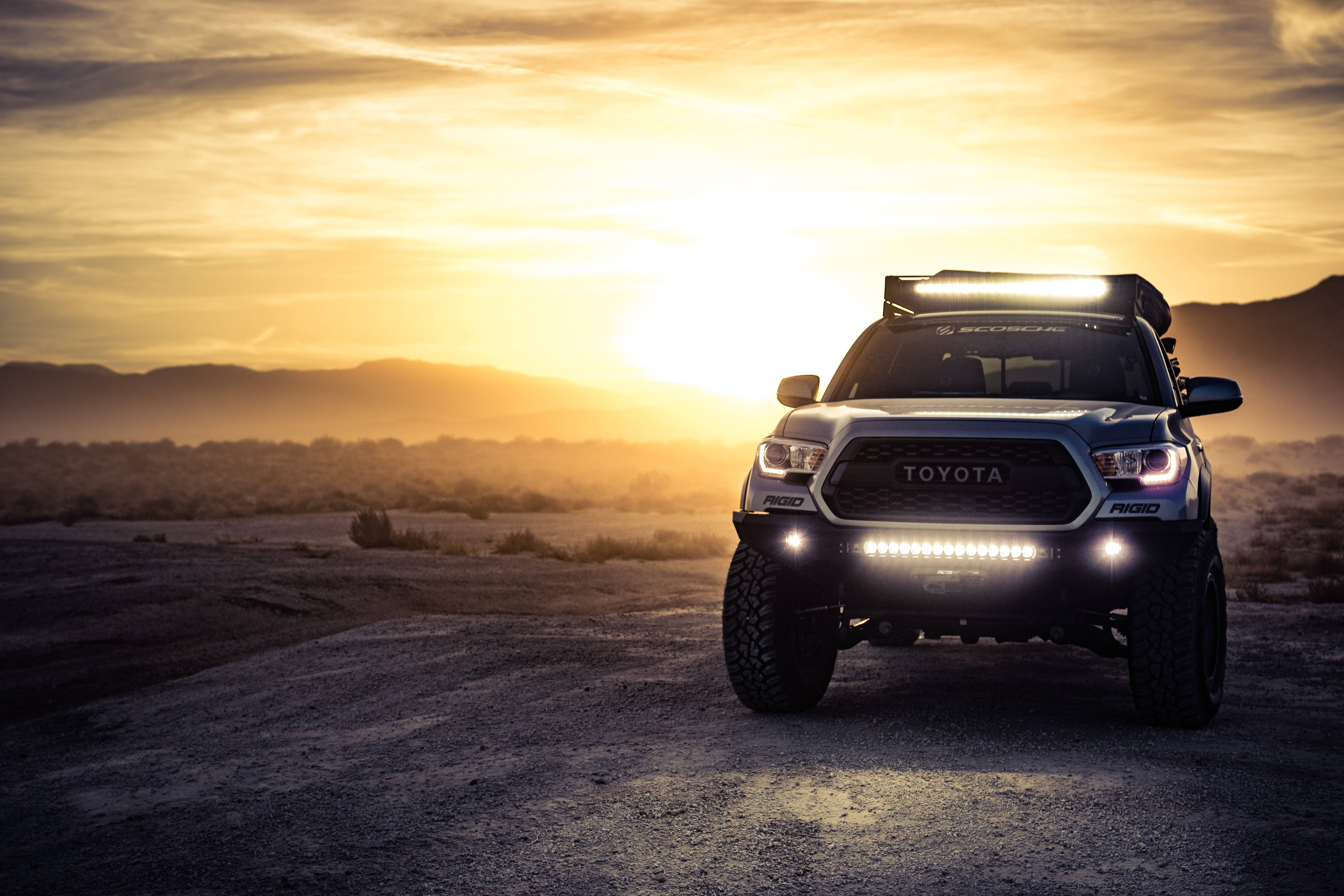 Toyota Tacoma, dusty desert road, sun sets, 5K Desktop Wallpaper
