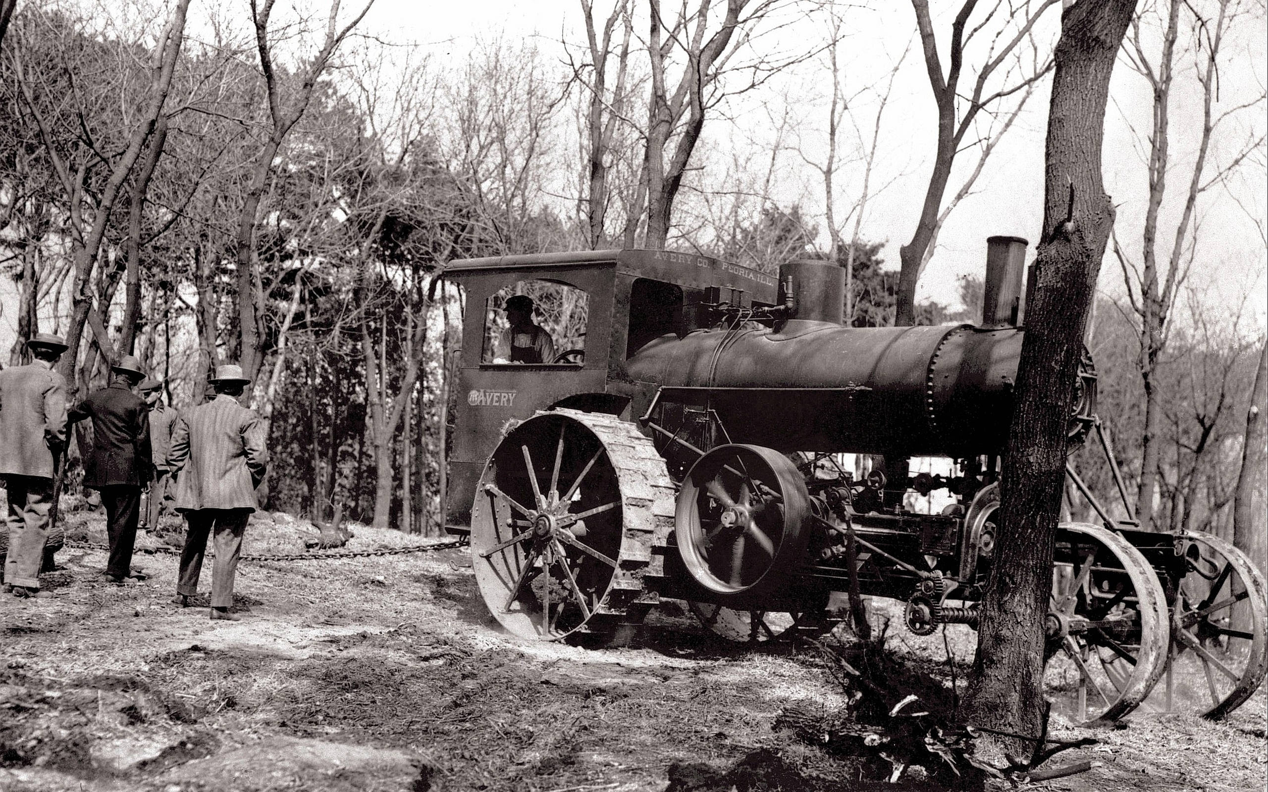 vintage steam tractor, large tracked wheels, leafless forest, 2K Desktop Wallpaper