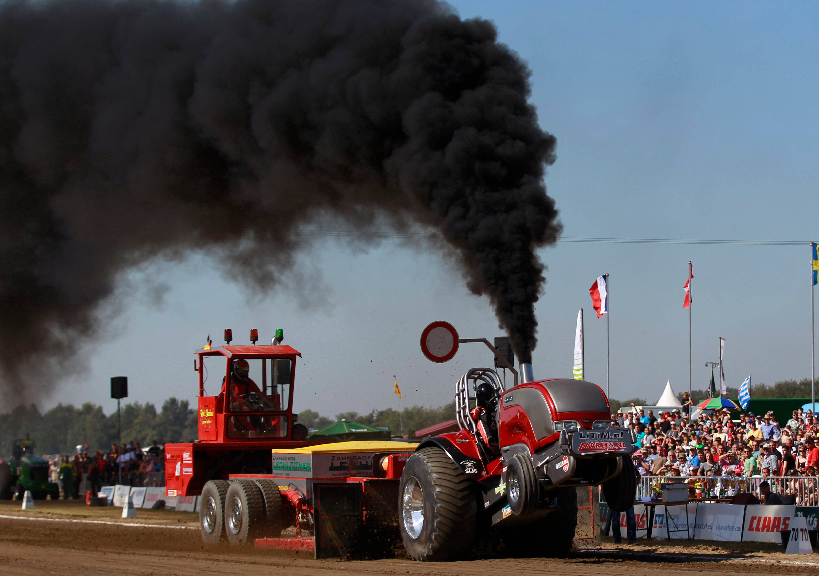 red pulling tractor, black smoke, dirt track, 2K Desktop Wallpaper