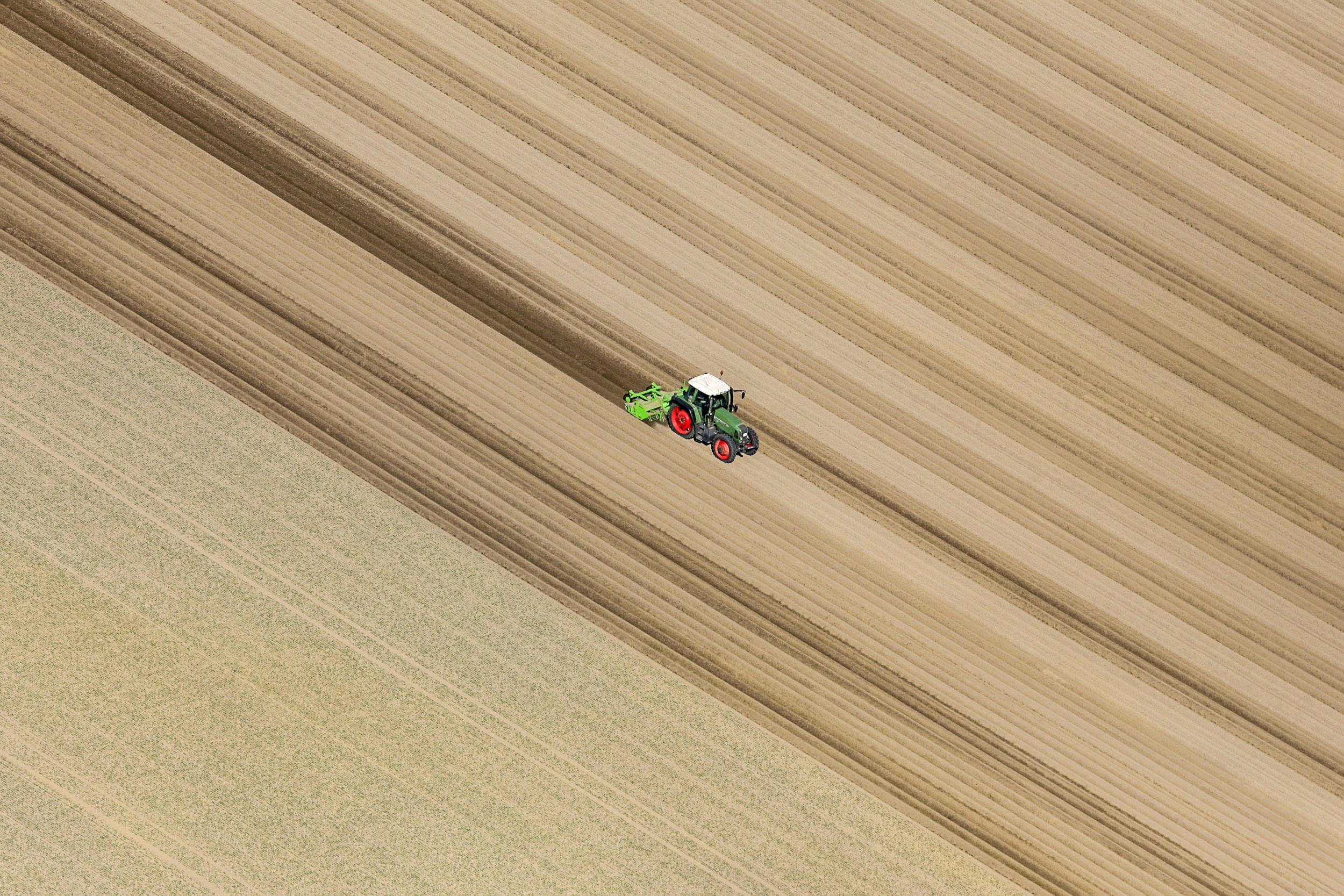green tractor, red wheels, vast golden-brown field, Full HD Desktop Wallpaper