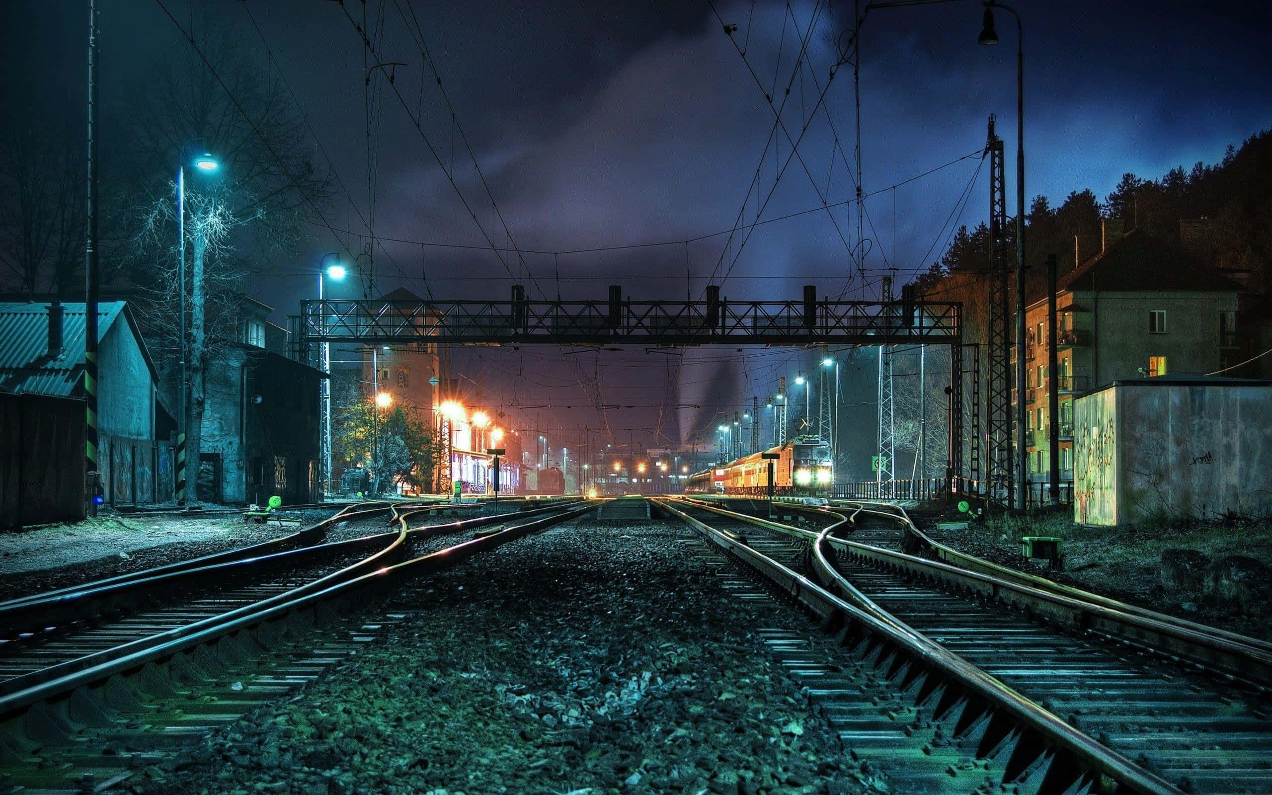 nighttime railway station, dark sky, glowing streetlights, 2K Desktop Wallpaper