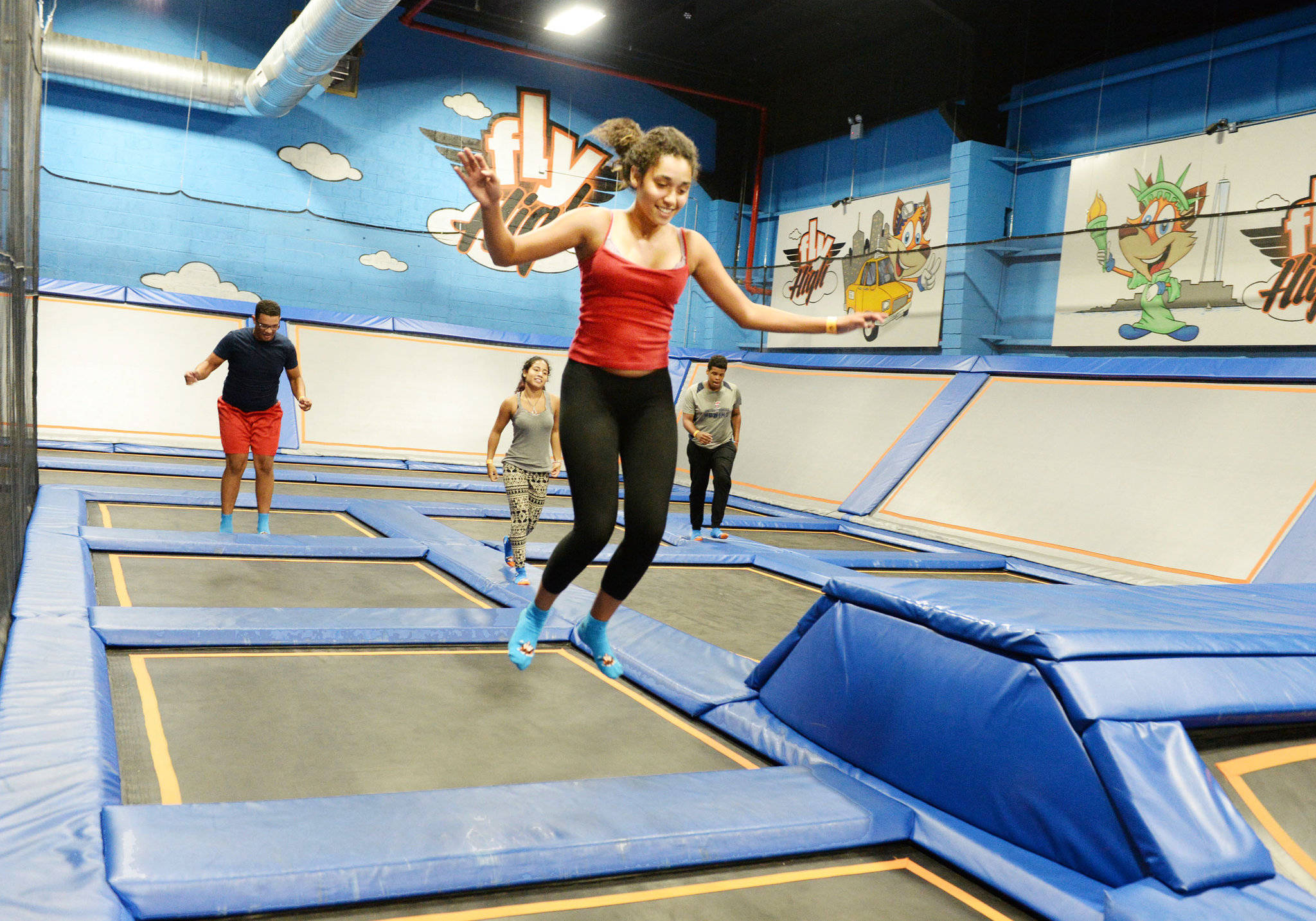 indoor trampoline park, colorful cartoon murals, joyful woman, Full HD Desktop Wallpaper
