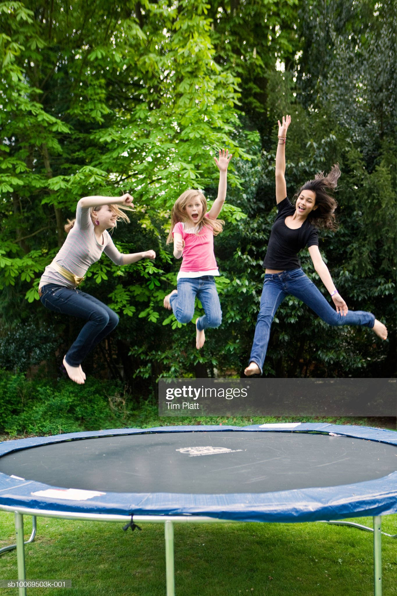 trampoline, three girls, lush green trees, Full HD Phone Wallpaper
