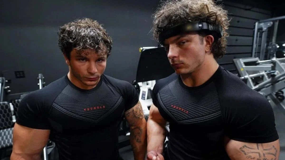 muscular twin brothers, black gym shirts, dimly lit weight room, SD Desktop Wallpaper