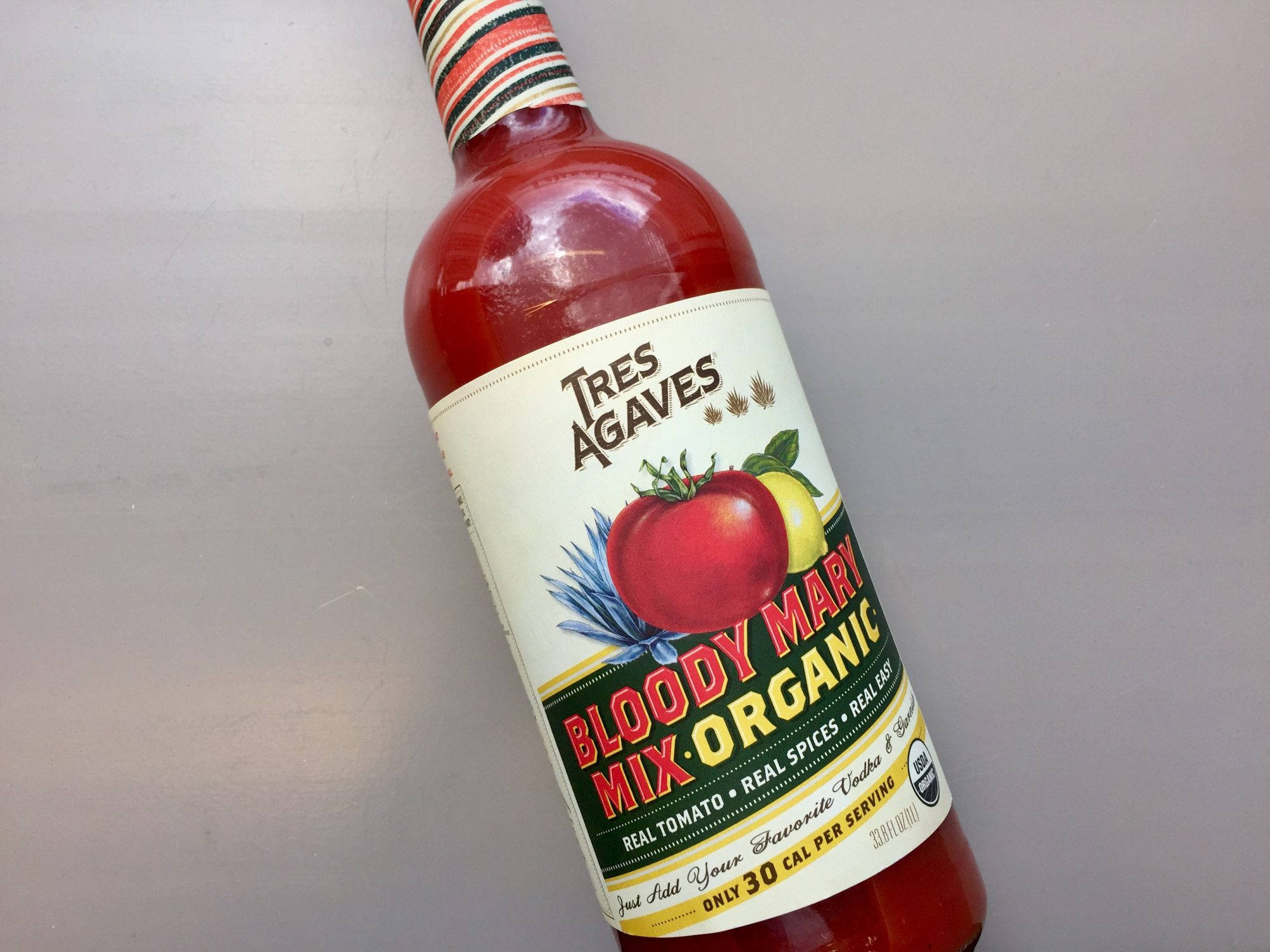 Tres Agaves Bloody Mary Mix, vibrant red bottle, plain gray surface, Full HD Desktop Wallpaper