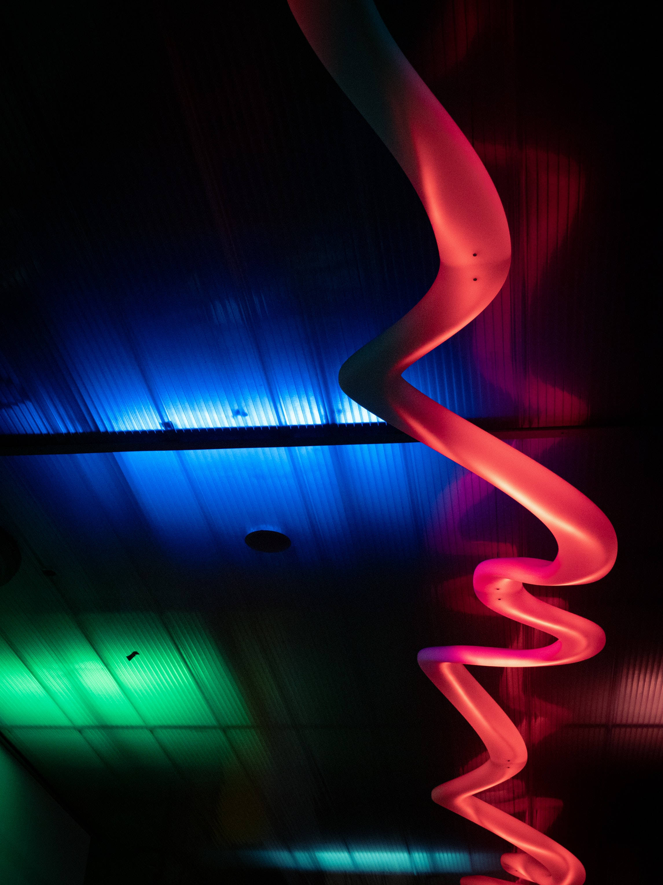 red spiral sculpture, dark ceiling, blue neon light, 2K Phone Wallpaper