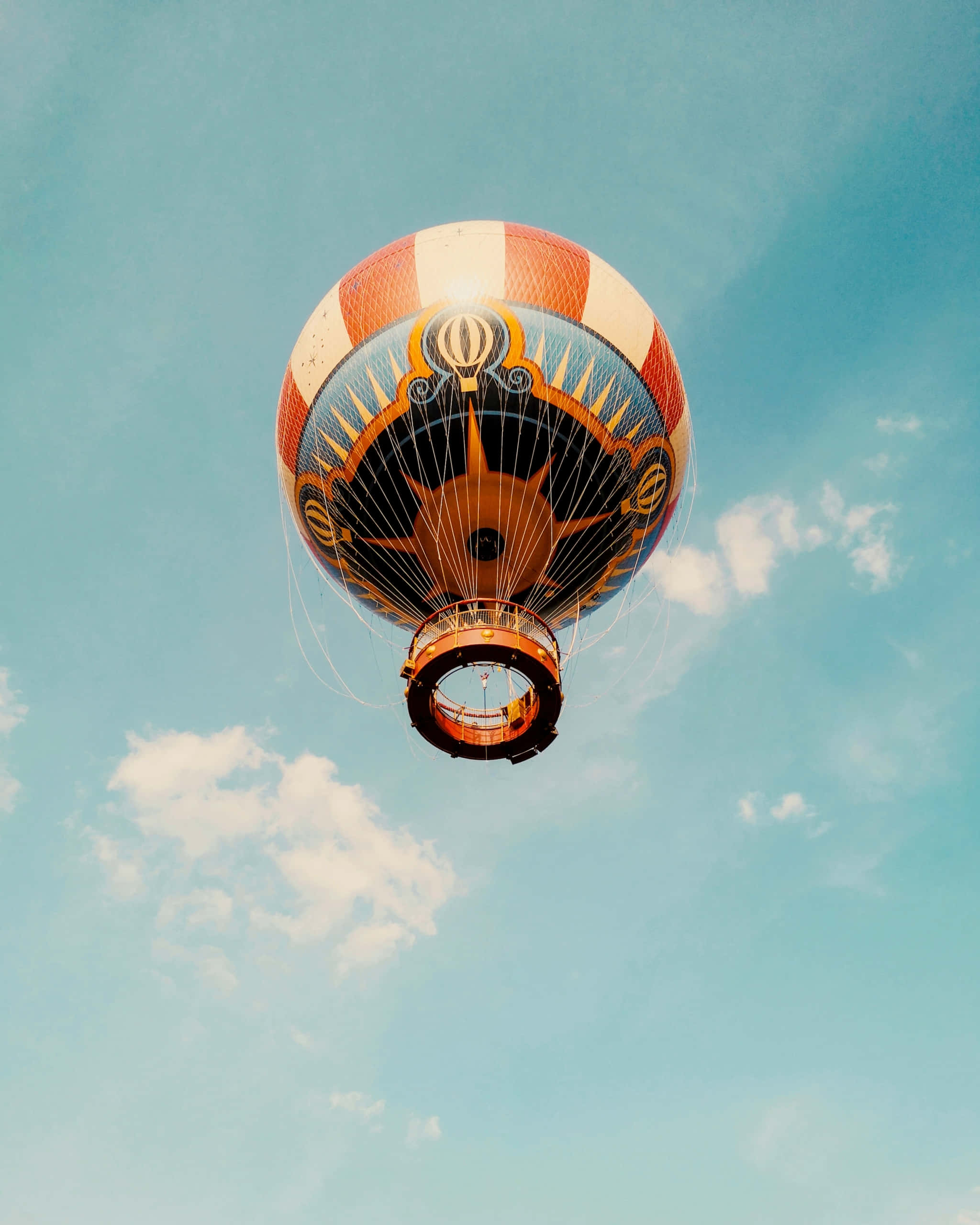 hot air balloon, orange white and blue stripes, soft blue sky, 2K Phone Wallpaper