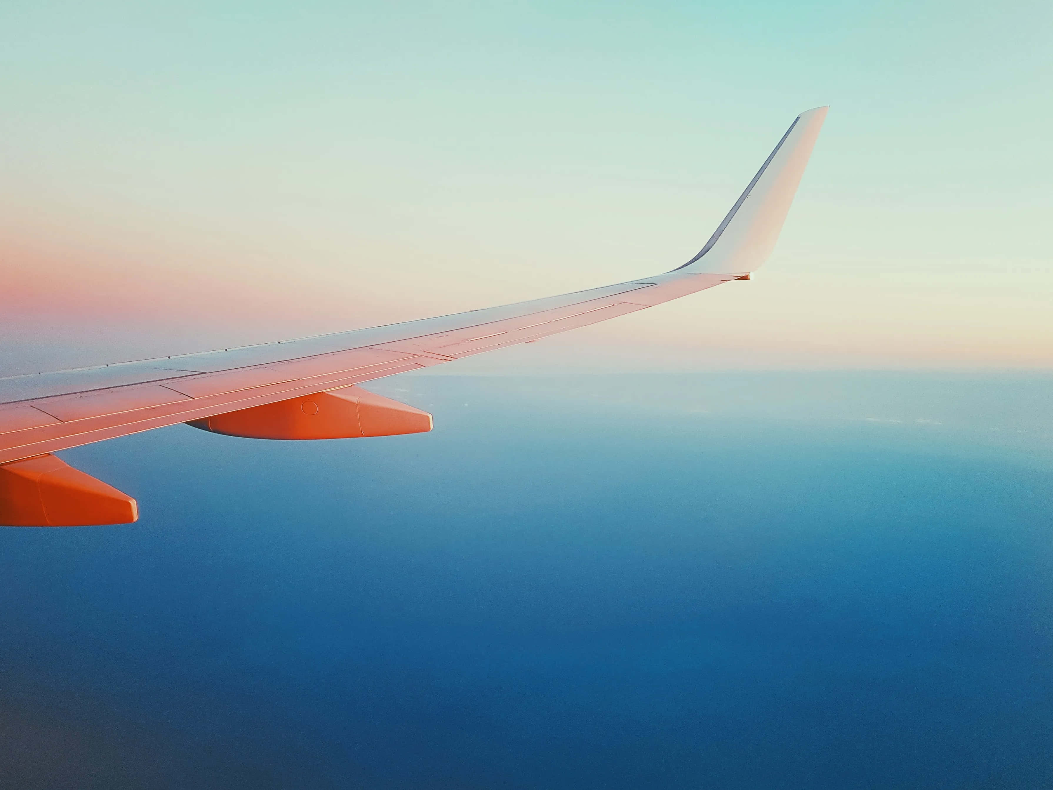Sunset Wing View Above Clouds, aircraft wing, vast blue ocean, 2K Desktop Wallpaper