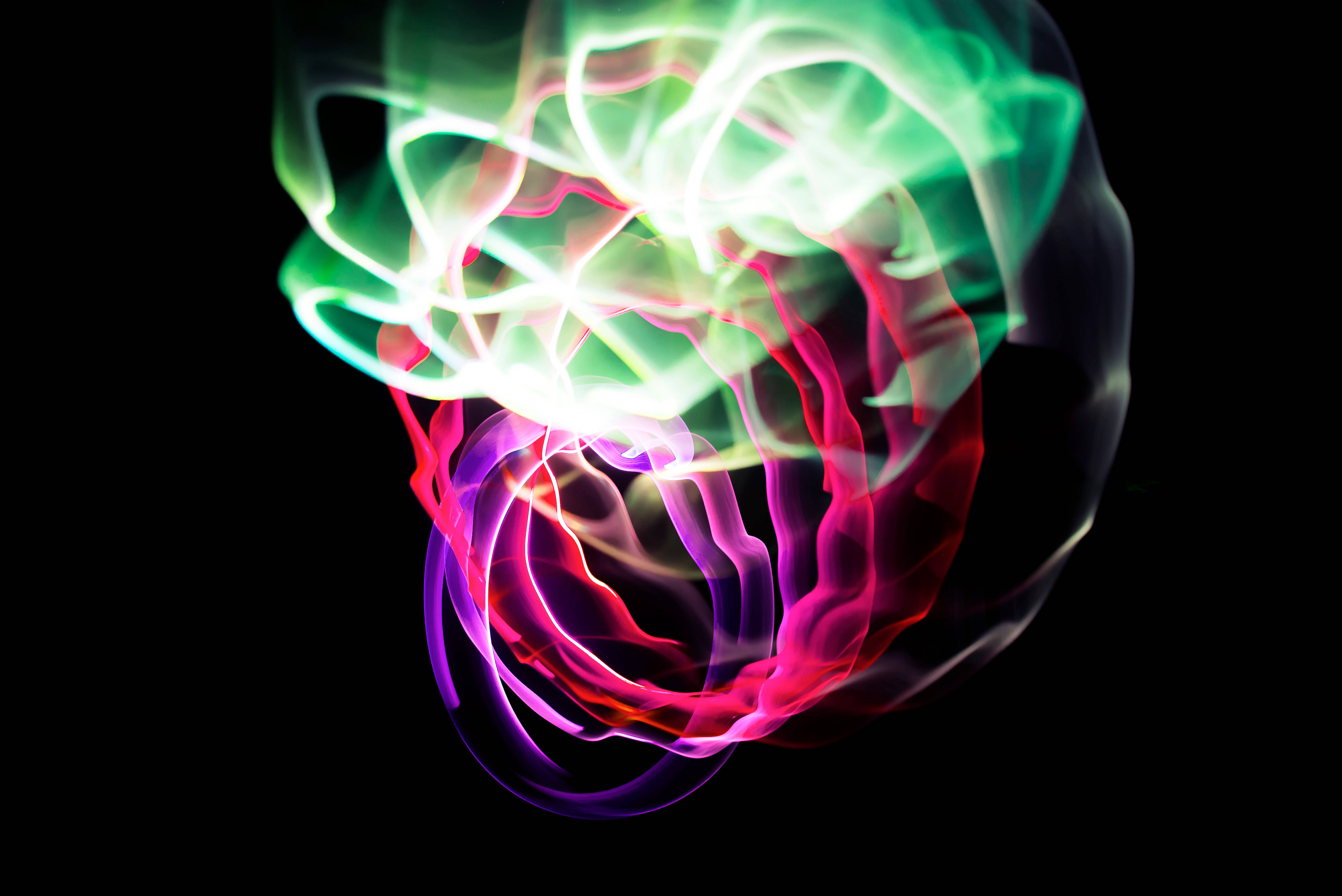neon light trails, glowing green pink and purple, stark black background, 5K Desktop Wallpaper